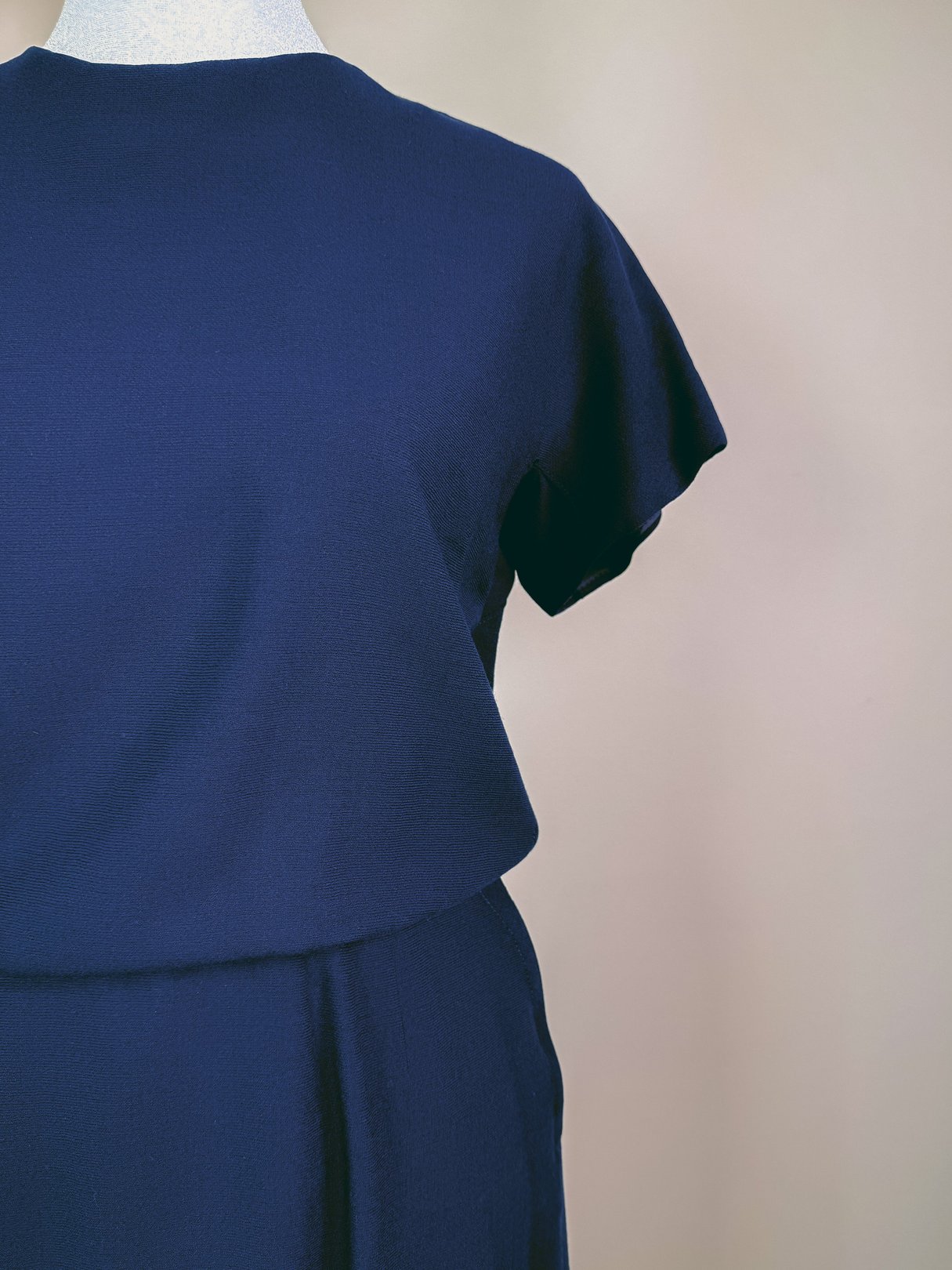 Navy blue women's dress set from the 1960s featuring short sleeves and a layered design.