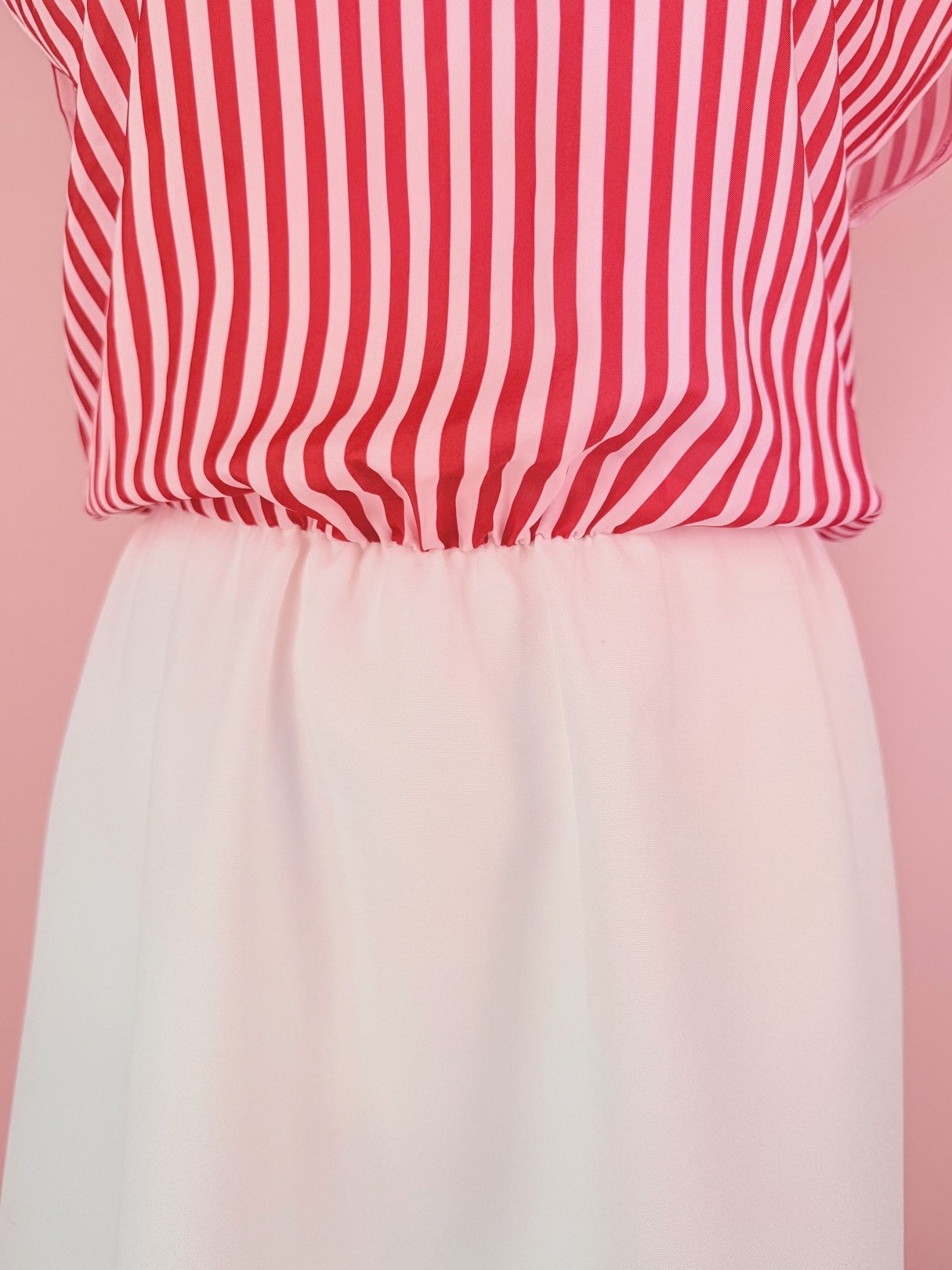 Candy Stripe Dress featuring a red and white striped top with a gathered waist and a white skirt, characteristic of 1970s women's fashion.
