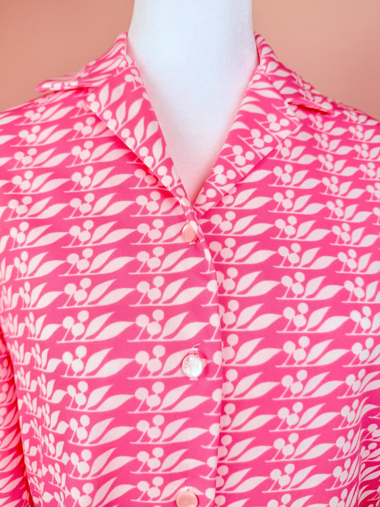 1970s women's Cherry Petal Blouse in a pink print featuring a leaf pattern and button closure.