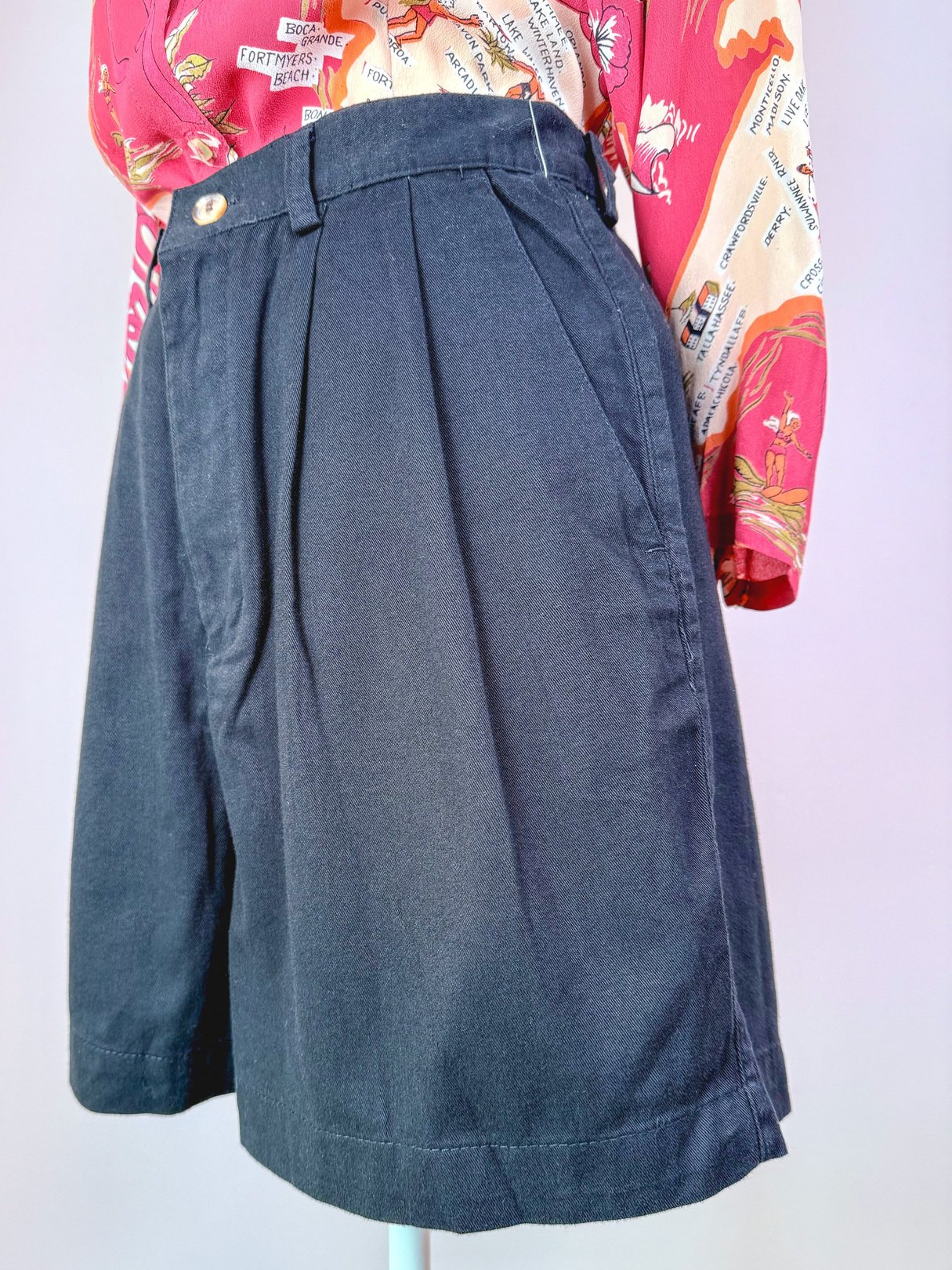 Black women's shorts with pleats, showcasing a 1980s style.