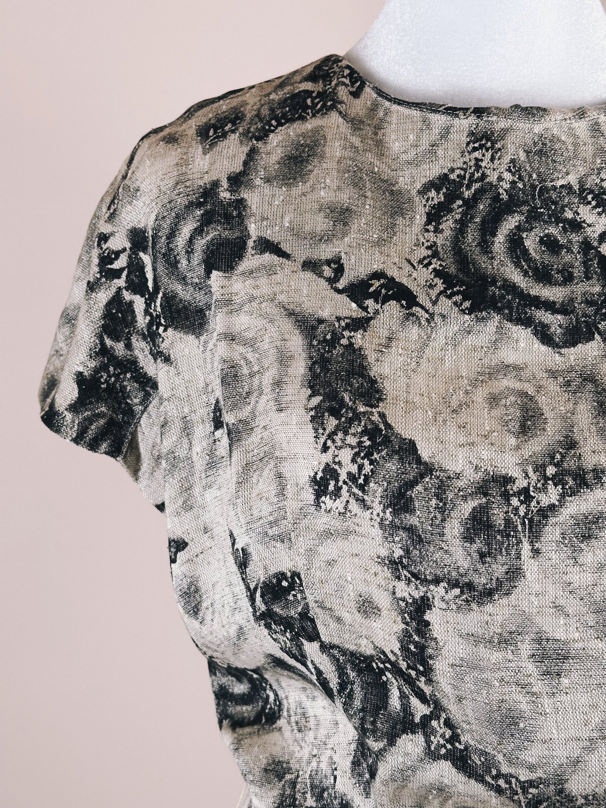 1950s black and cream dress featuring a floral rose pattern, designed for women.