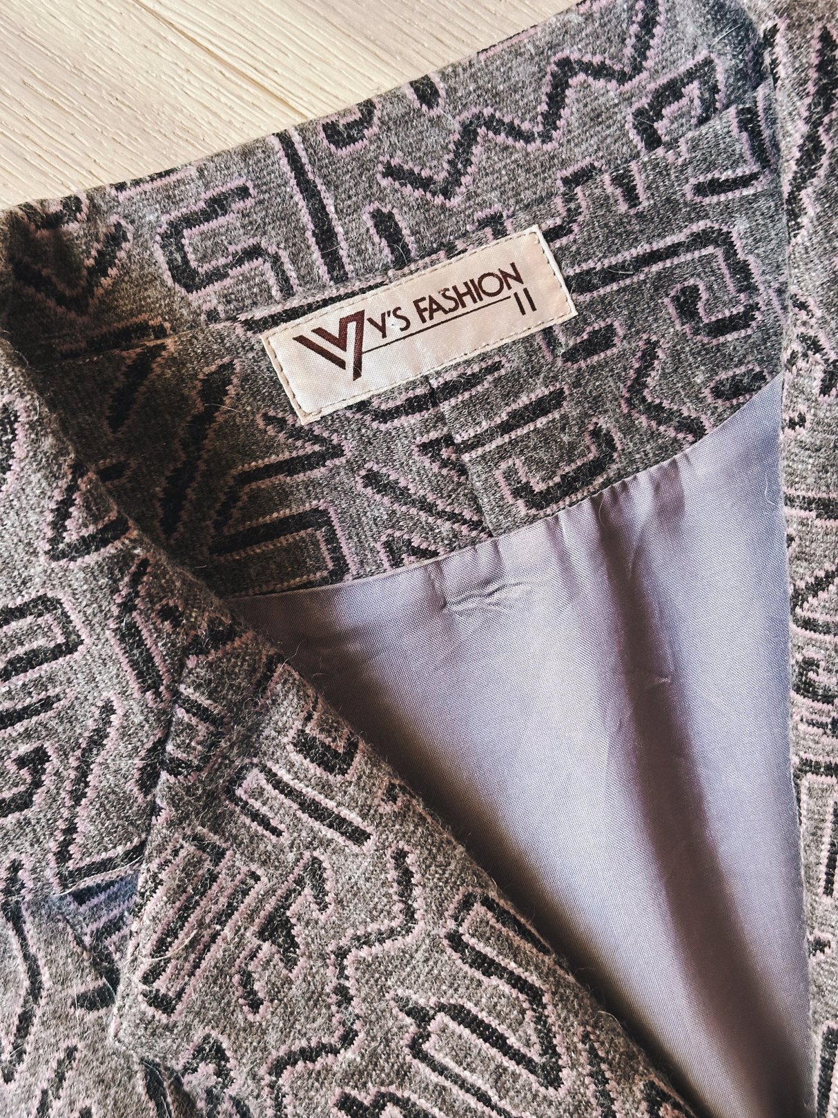 Pink geometric-patterned blazer from the 1980s featuring a label that reads "W's Fashion.