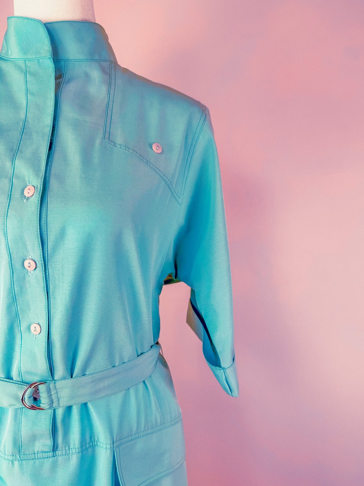 Skyline Shift Dress in sky blue featuring a collared neckline, front button closure, and belted waist, inspired by 1960s fashion.