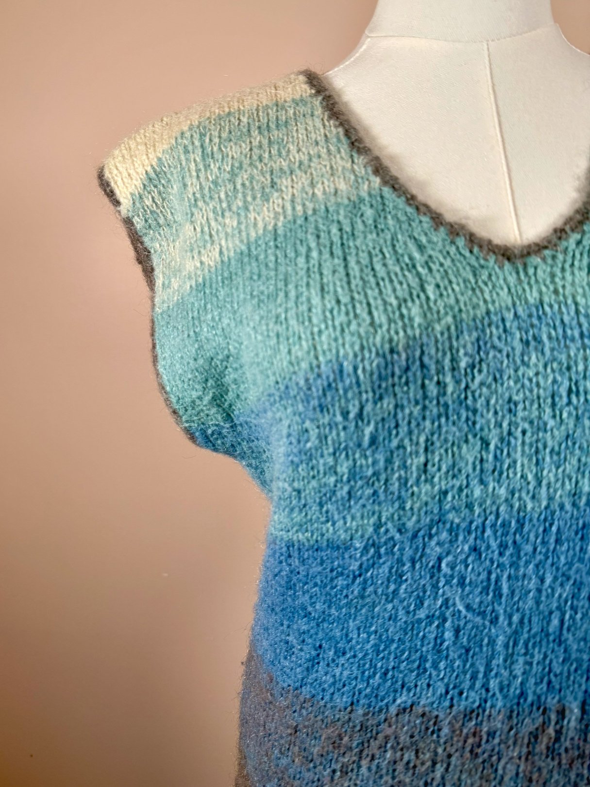 1970s women's blue mohair sweater vest featuring a V-neck and varying shades of blue and cream.