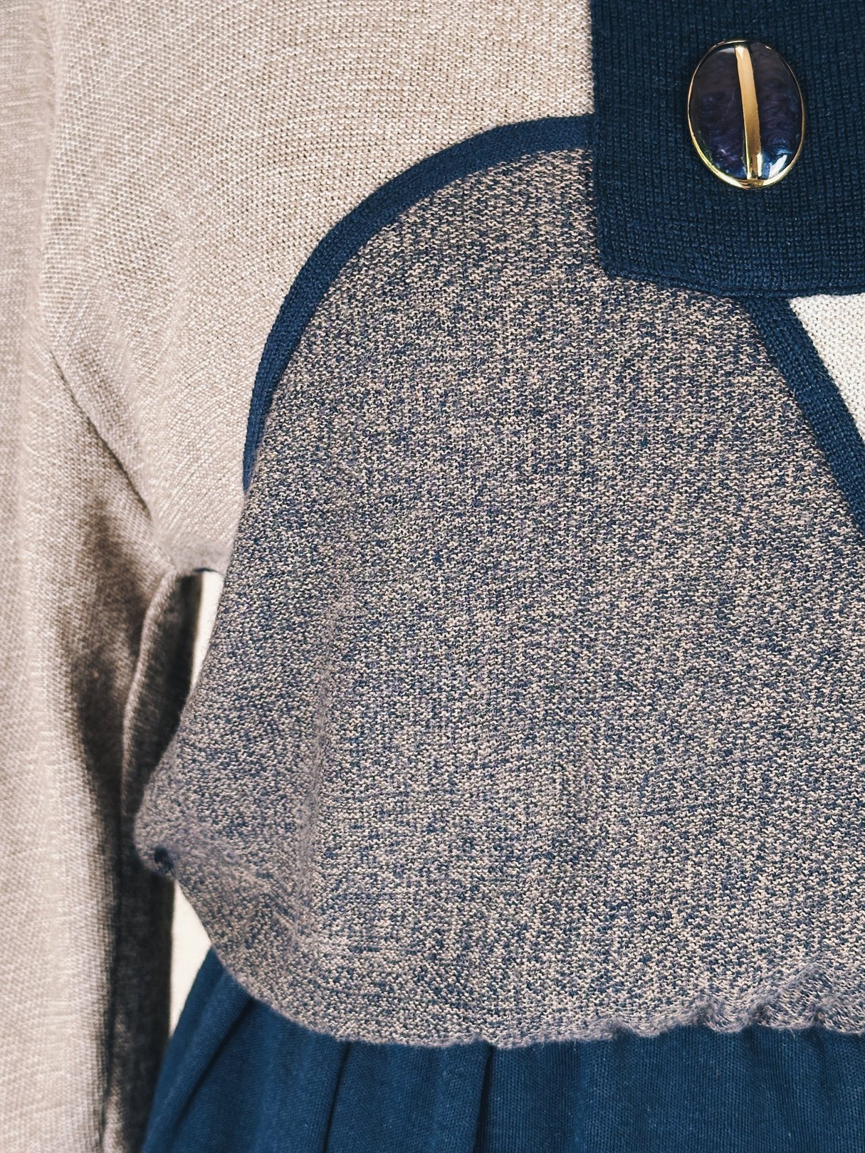 Navy blue 1980s artist sweater dress featuring a textured bodice and contrasting collar with a decorative button.