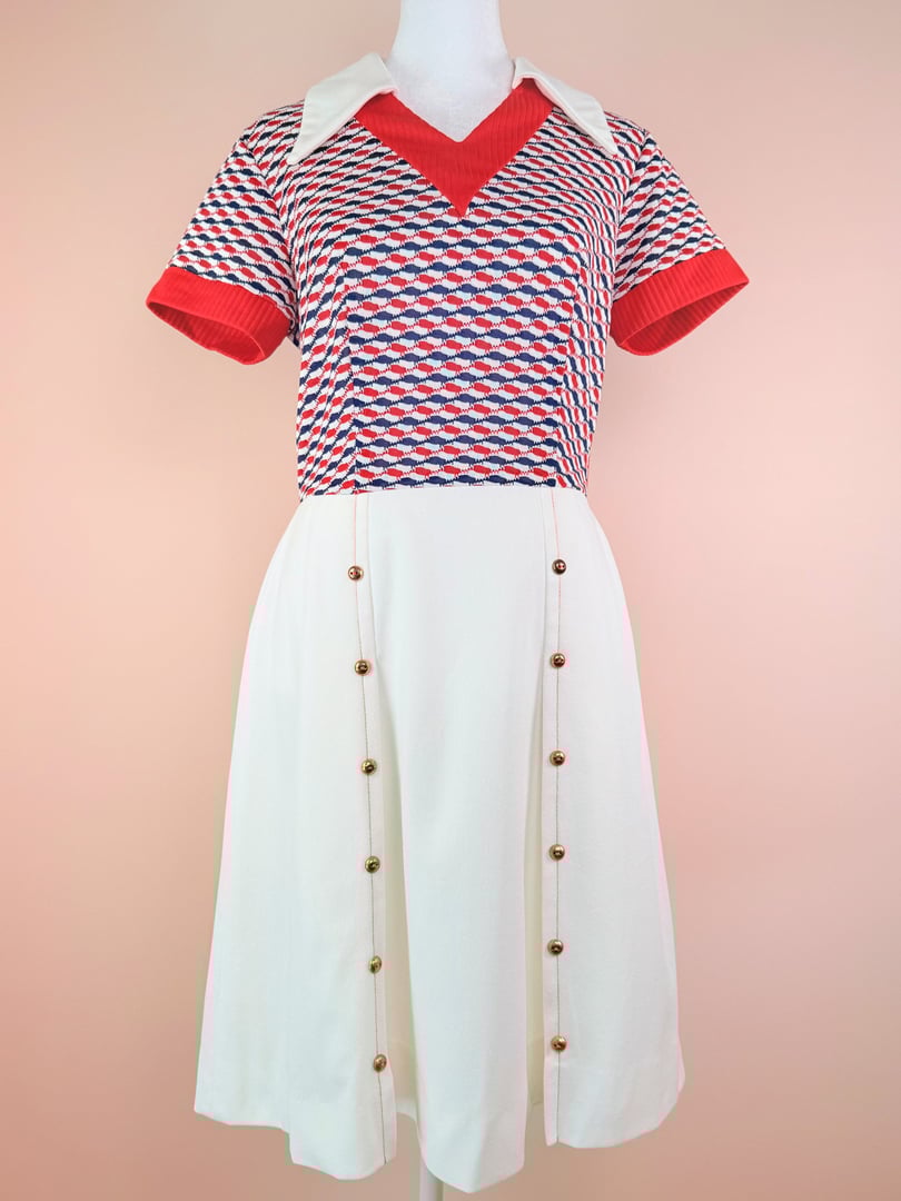 Red and white 1970s women's Bottle Rocket Dress featuring a geometric patterned top and a solid white skirt with button details.