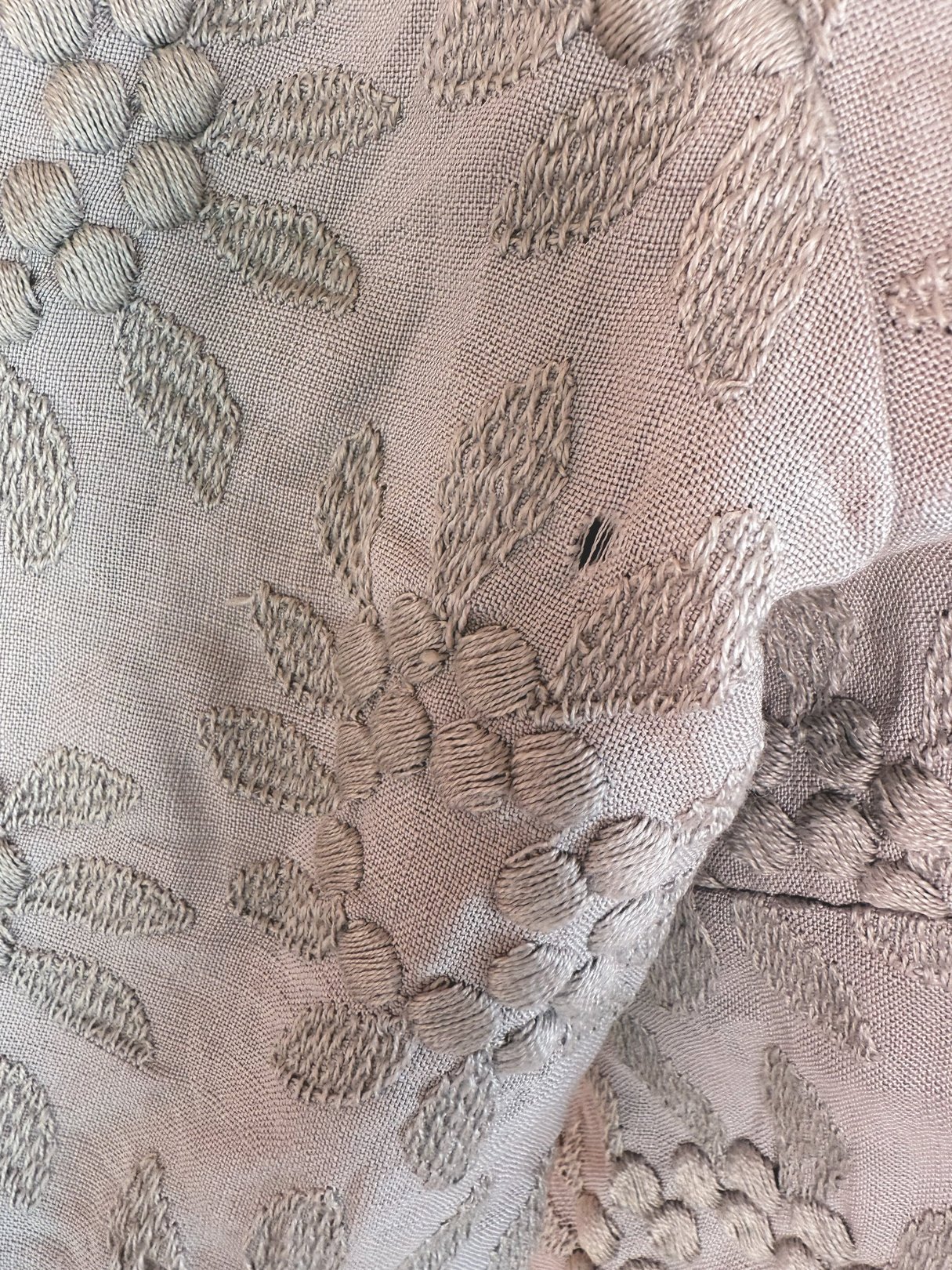 Slate blue 1950s women's dress featuring an embossed floral pattern.