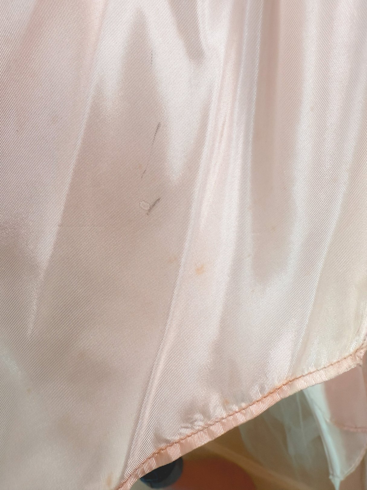 The Twilight Waltz Dress is a women's silver dress from the 1950s, featuring a sparkly fabric with visible stains.