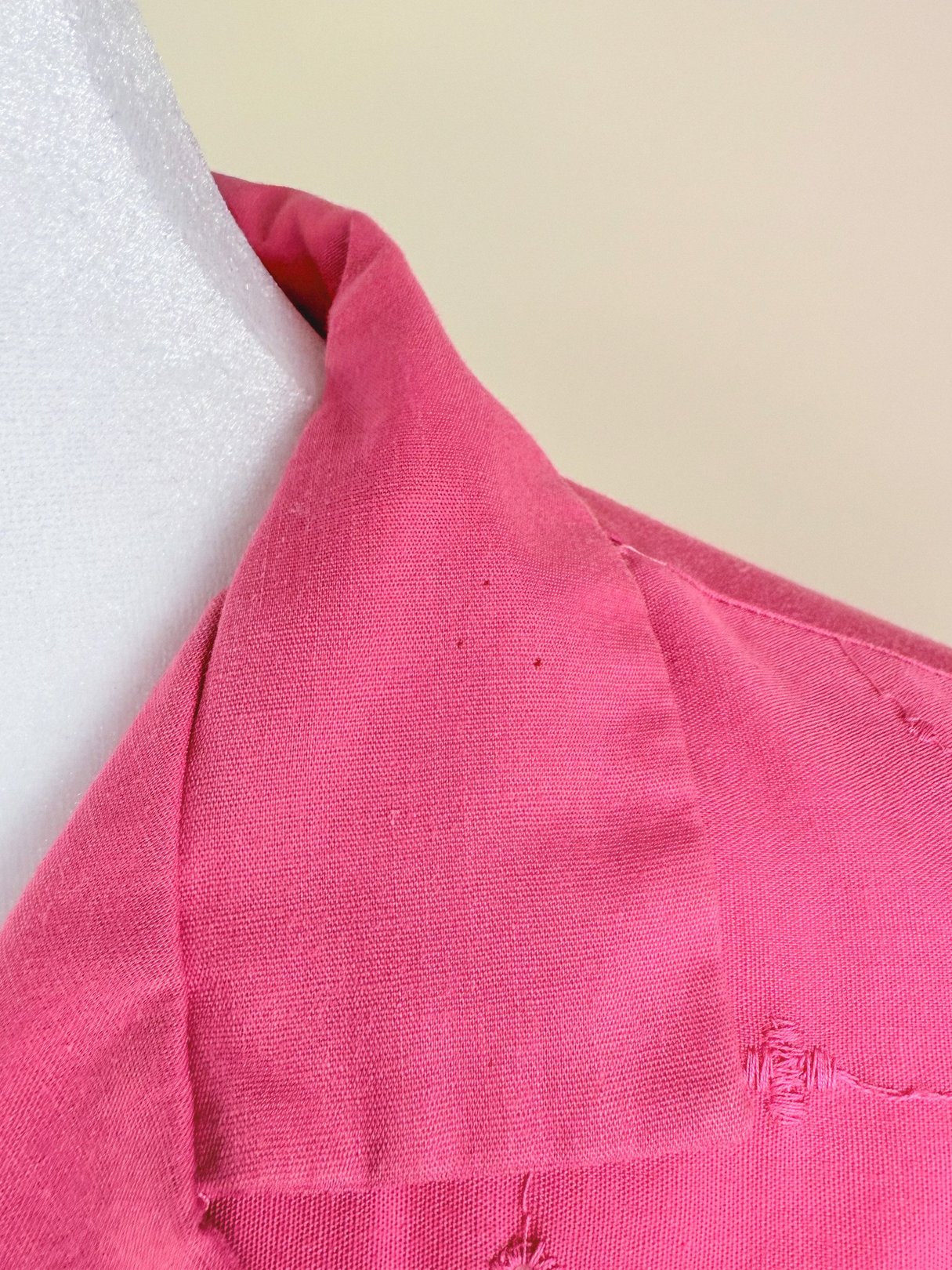 Pink short-sleeved top for women from the 1980s featuring a collared neckline and textured fabric.