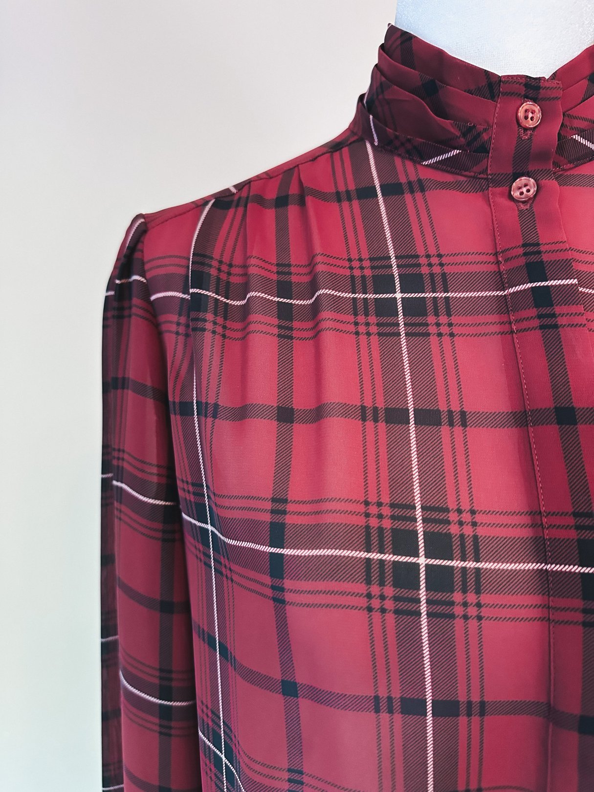 Maroon 1960s women's blouse featuring a plaid pattern and a high collar with button closures.
