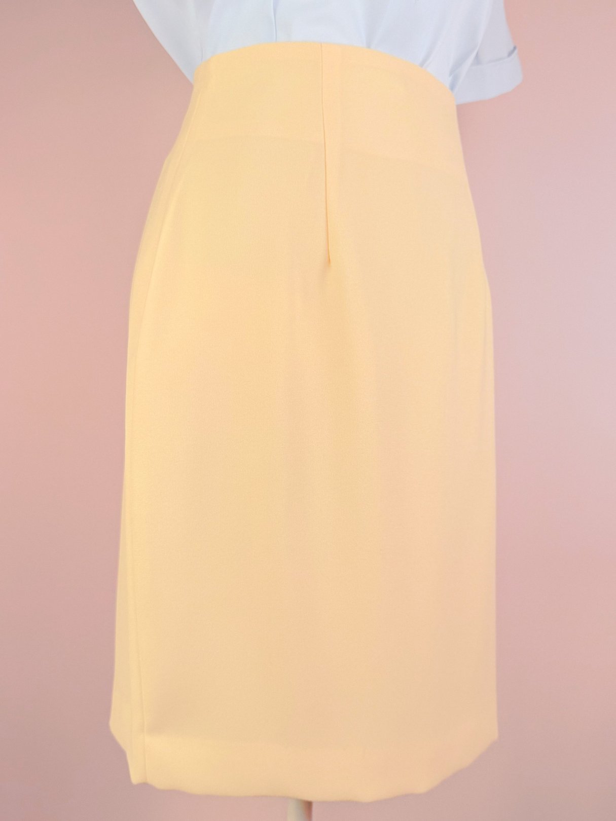 Buttery yellow 1990s women's skirt with a straight cut and back vent.