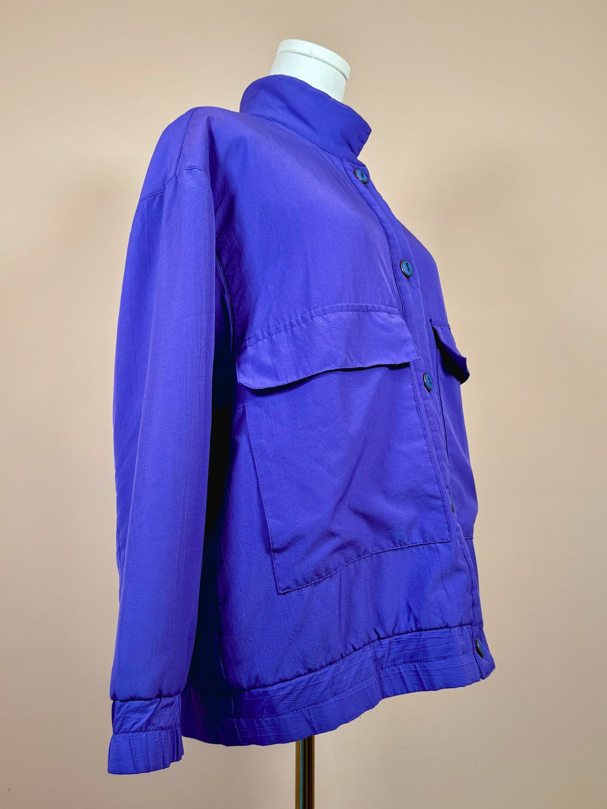 Vibrant violet 1980s women's jacket featuring a collared neckline and front pockets.