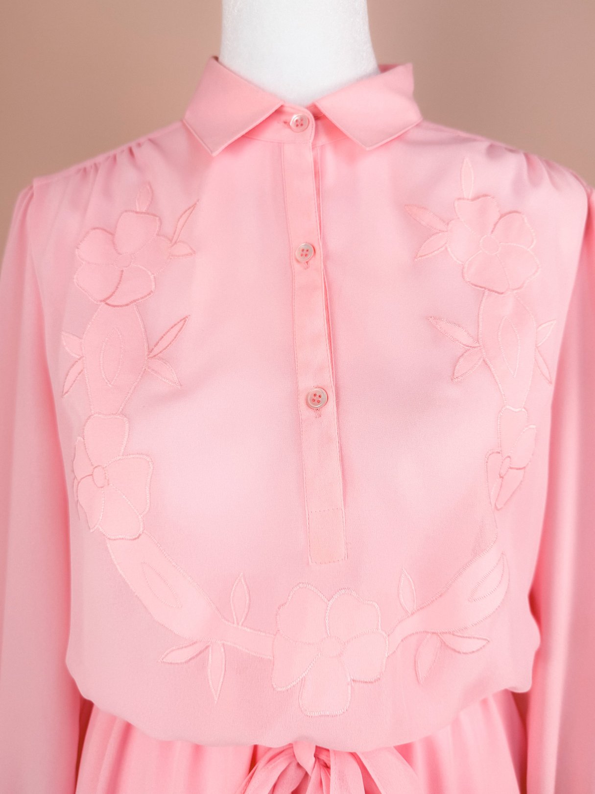 Bubble gum pink 1980s Flora Belle Dress featuring floral embroidery and a button-up collar.