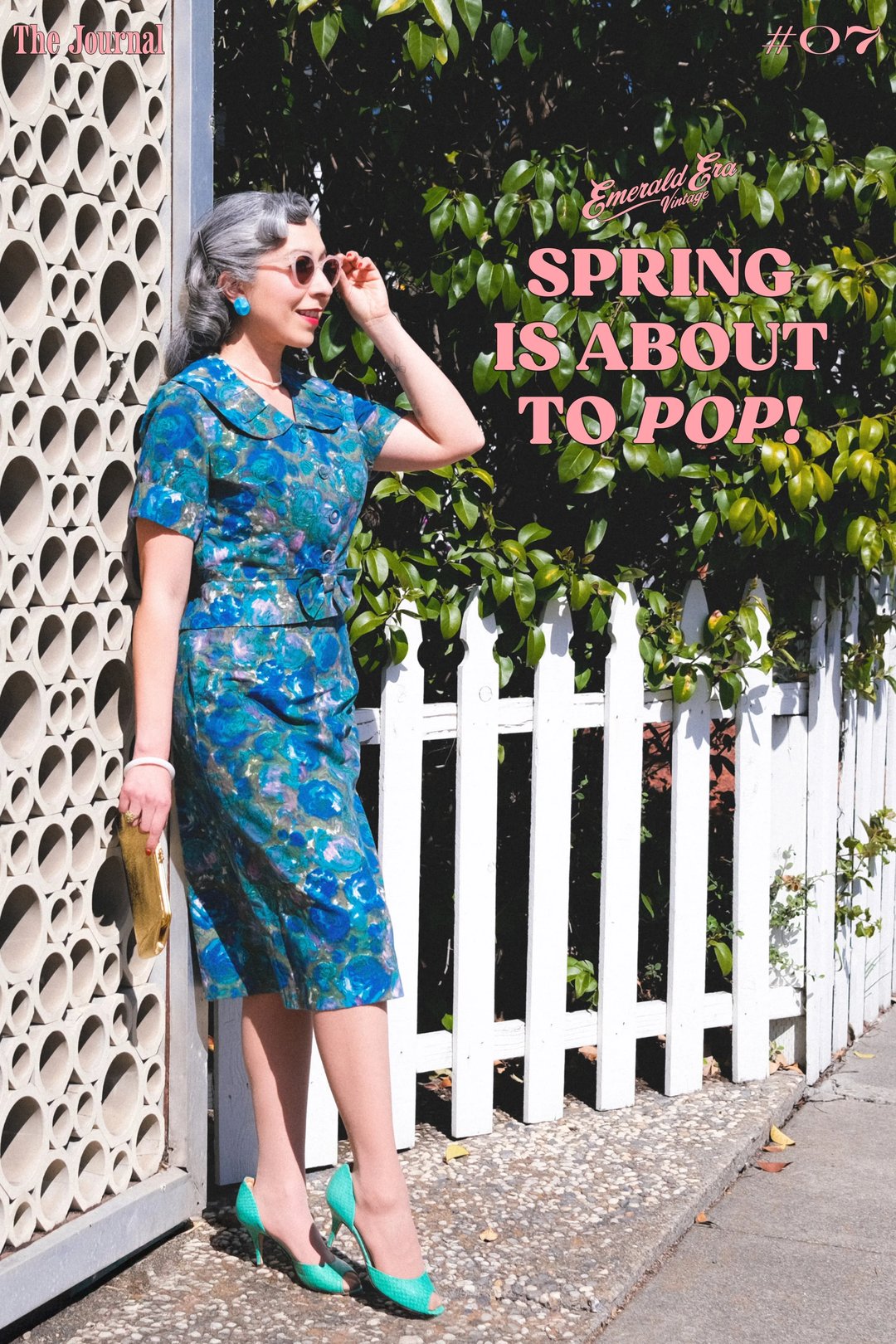 A woman in a vintage floral dress poses outdoors by a white picket fence, promoting a spring fashion collection.
