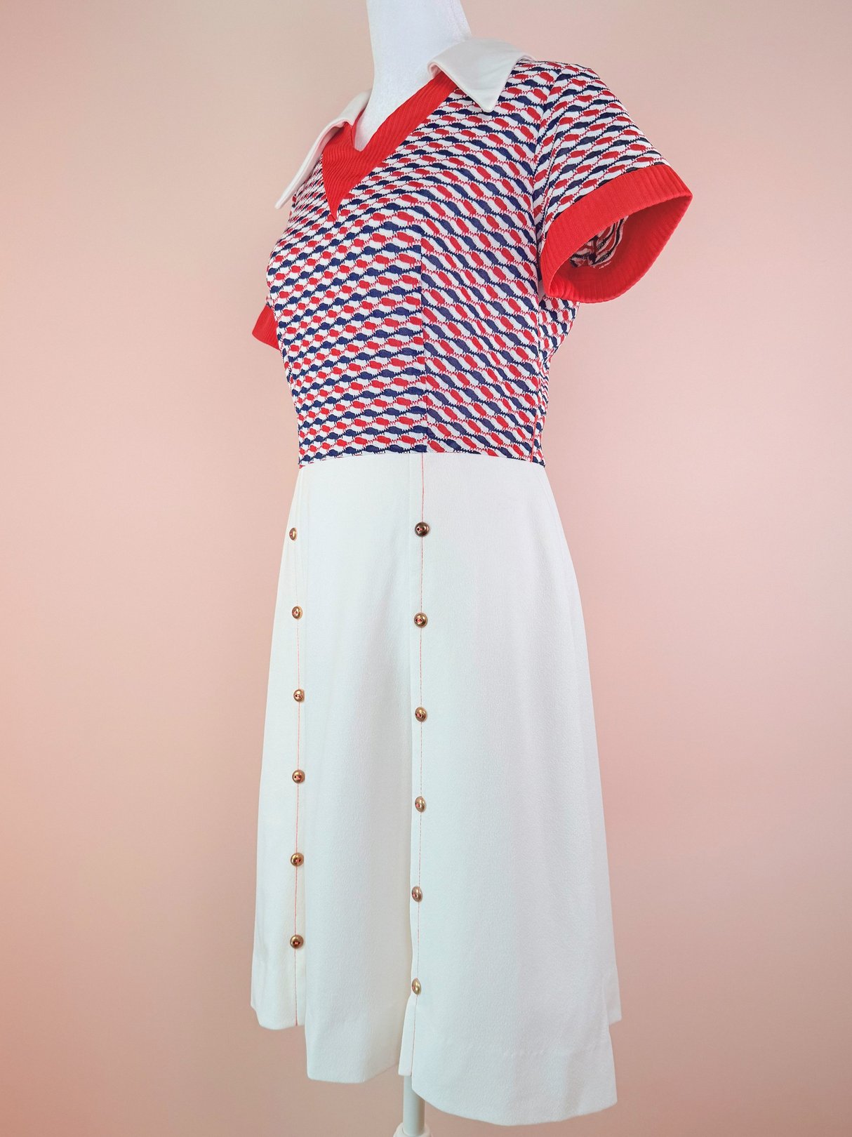 Red and white 1970s women's Bottle Rocket Dress featuring a multicolored patterned top and a button-down skirt.
