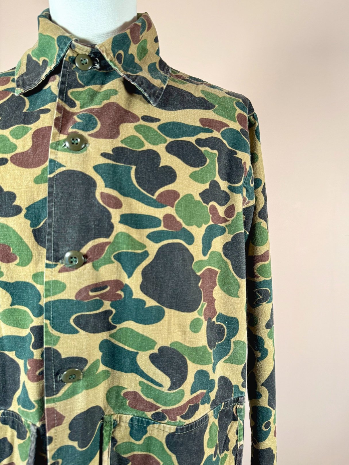 Camo jacket for men in 1970s style featuring camouflage green with brown and dark green patterns.