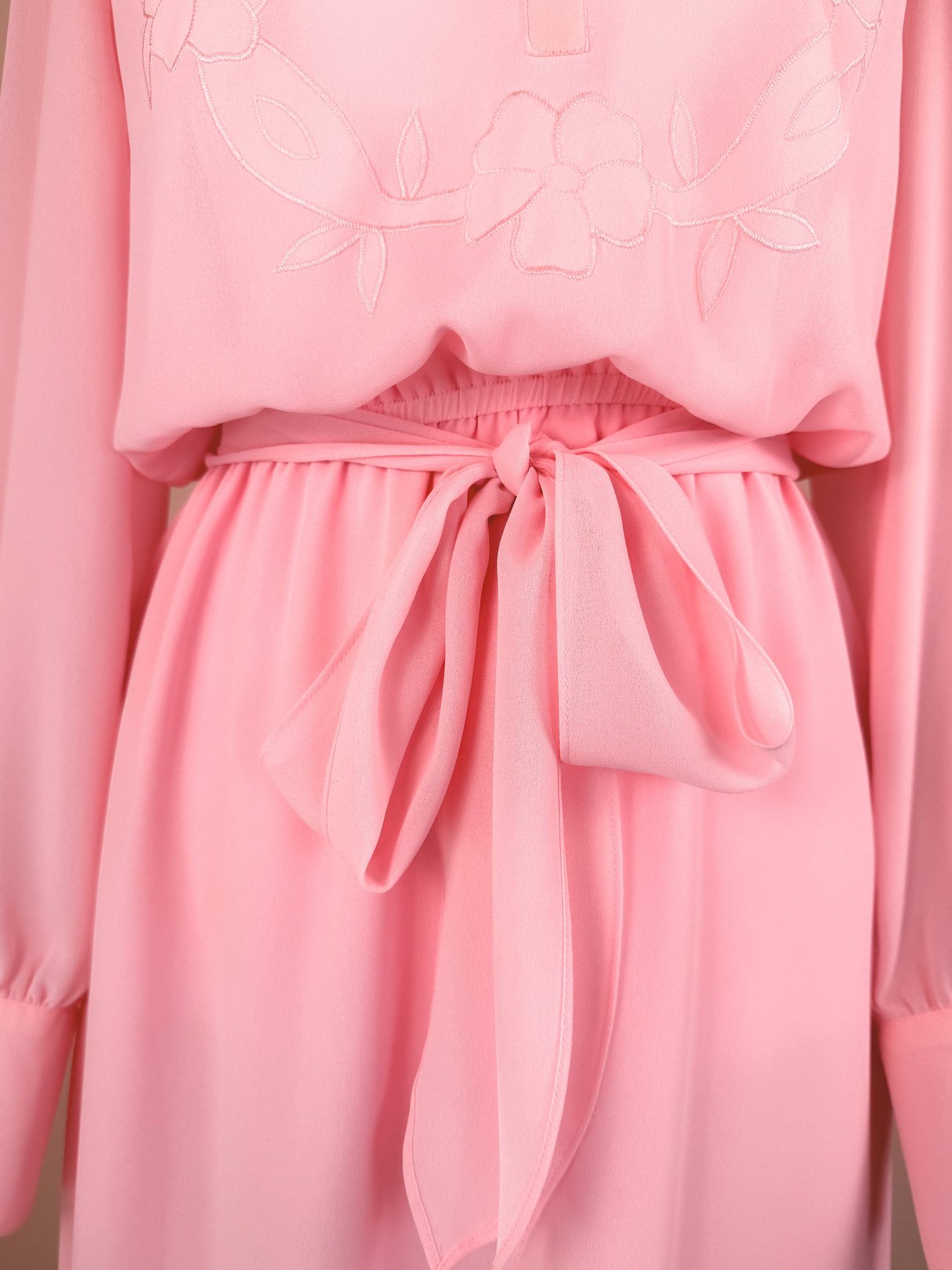 Bubble gum pink women's dress from the 1980s featuring a tied waist detail.