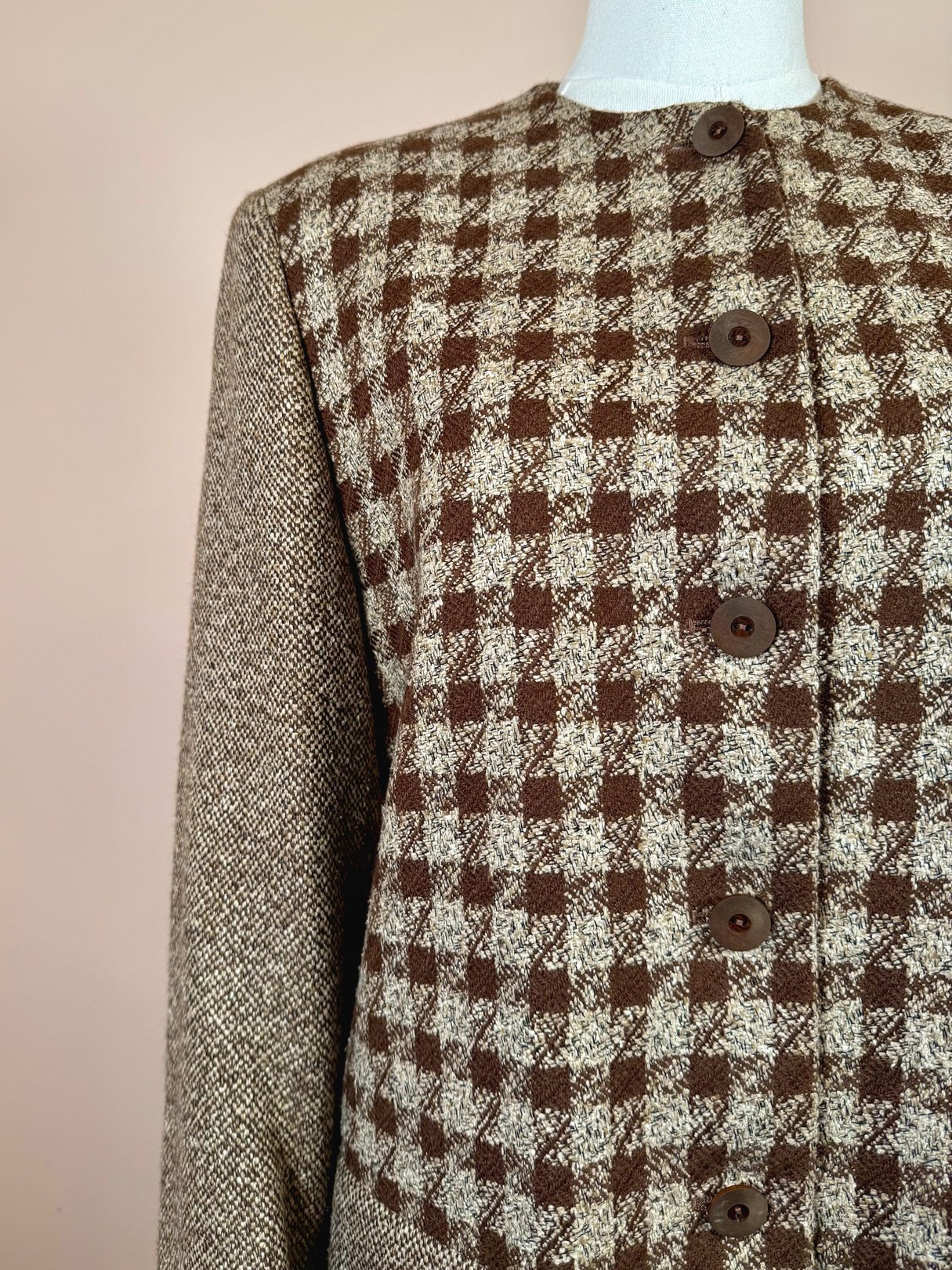 Brown tweed coat with a checkered pattern and button details, designed for women and reflective of 1990s fashion.