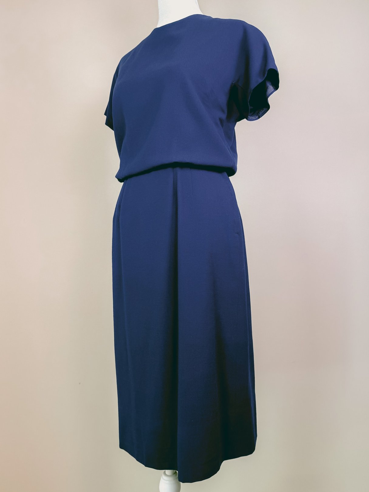 Navy blue women's dress set from the 1960s, featuring a short-sleeve top and a knee-length skirt.