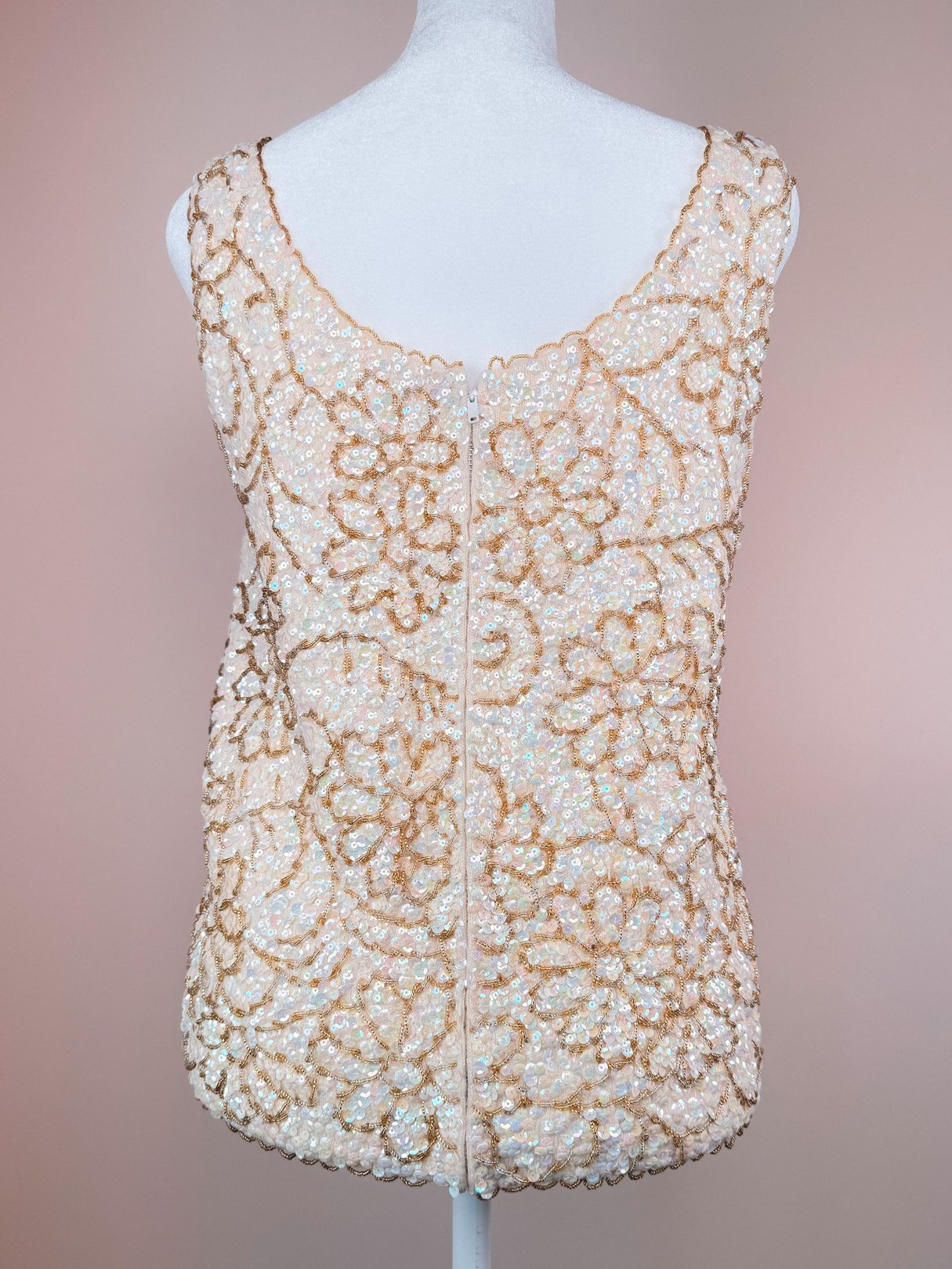 A white sleeveless top from the 1960s adorned with intricate gold floral beadwork, suitable for women and categorized under sparkle tops.