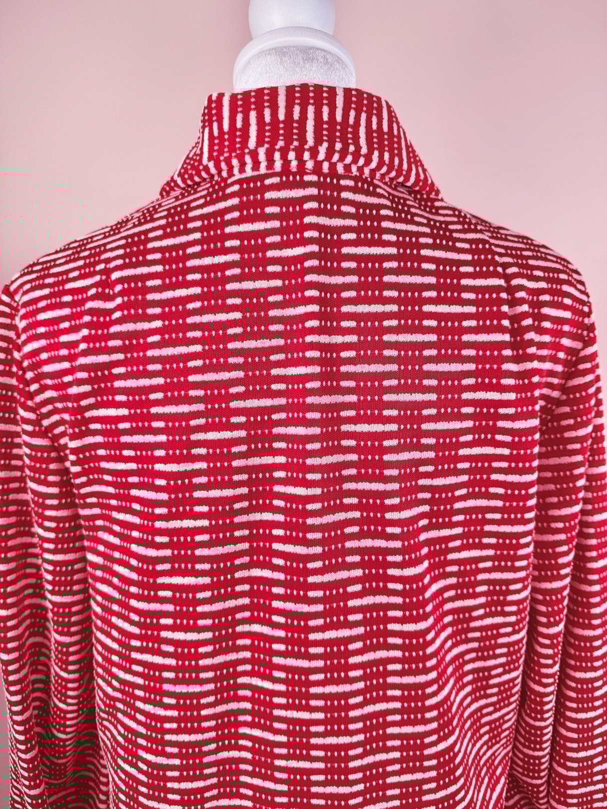 Red 1970s women's knit dress featuring a textured pattern of white lines and dots on the back.