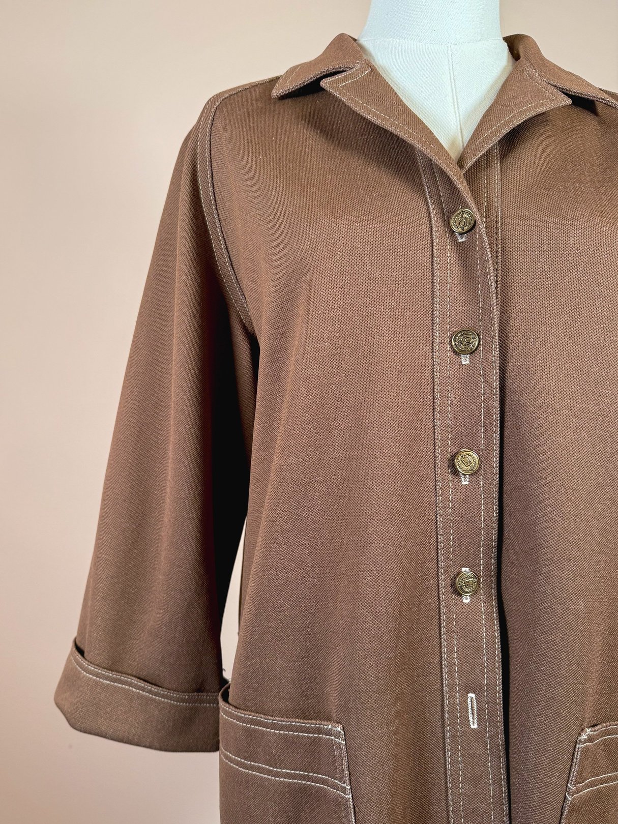 Chestnut brown women's jacket from the 1960s featuring a collared neckline, button front, and side pockets.