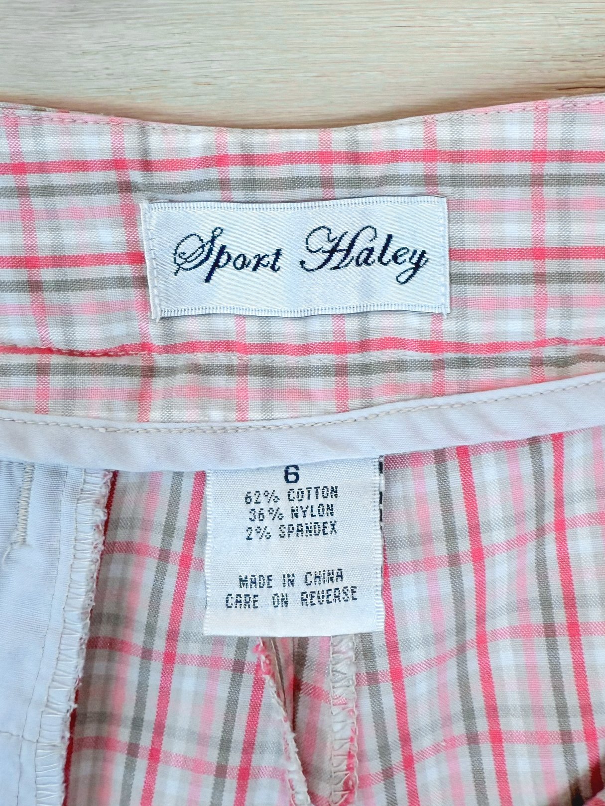 Pink plaid shorts labeled "Sport Haley," made of cotton, nylon, and spandex, designed for women in the 1980s.