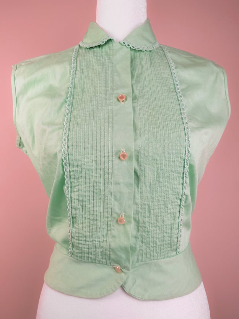 Mint green 1950s women's top with a pleated front and pearl-like button closures.