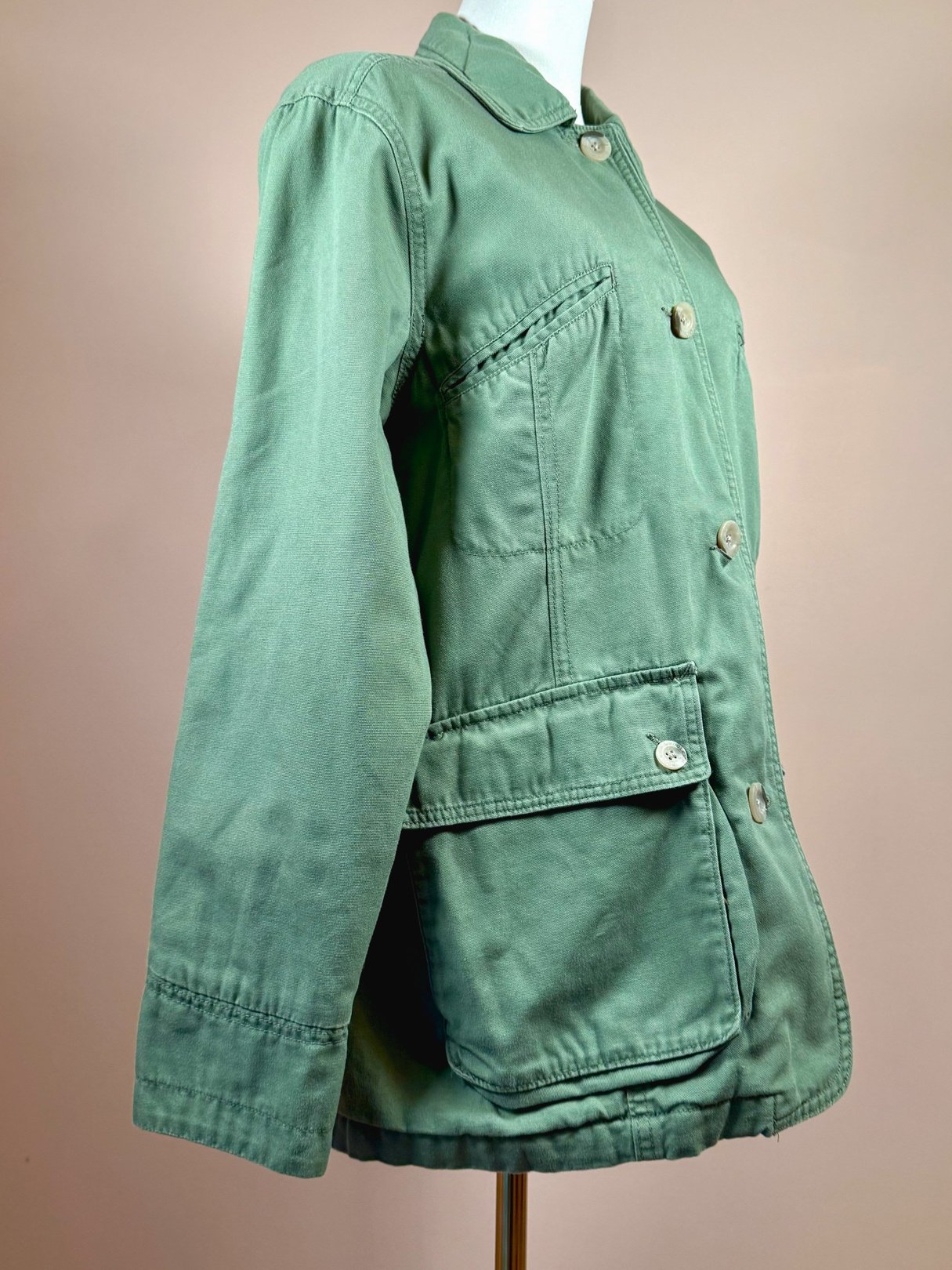 Sage quilted jacket for women from the 1970s featuring a button-up front and side pockets.