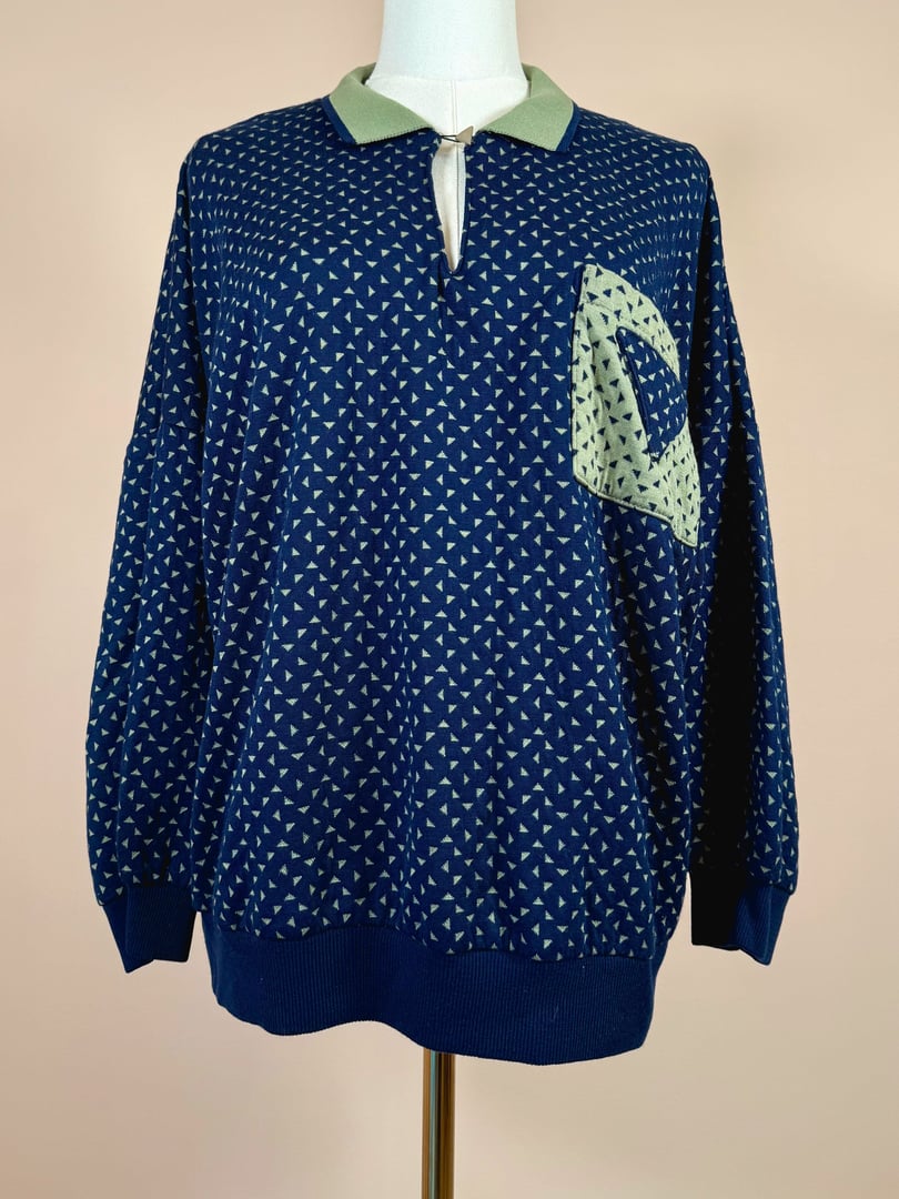 Navy blue women's triangle top from the 1980s featuring a patterned design and a green collar.