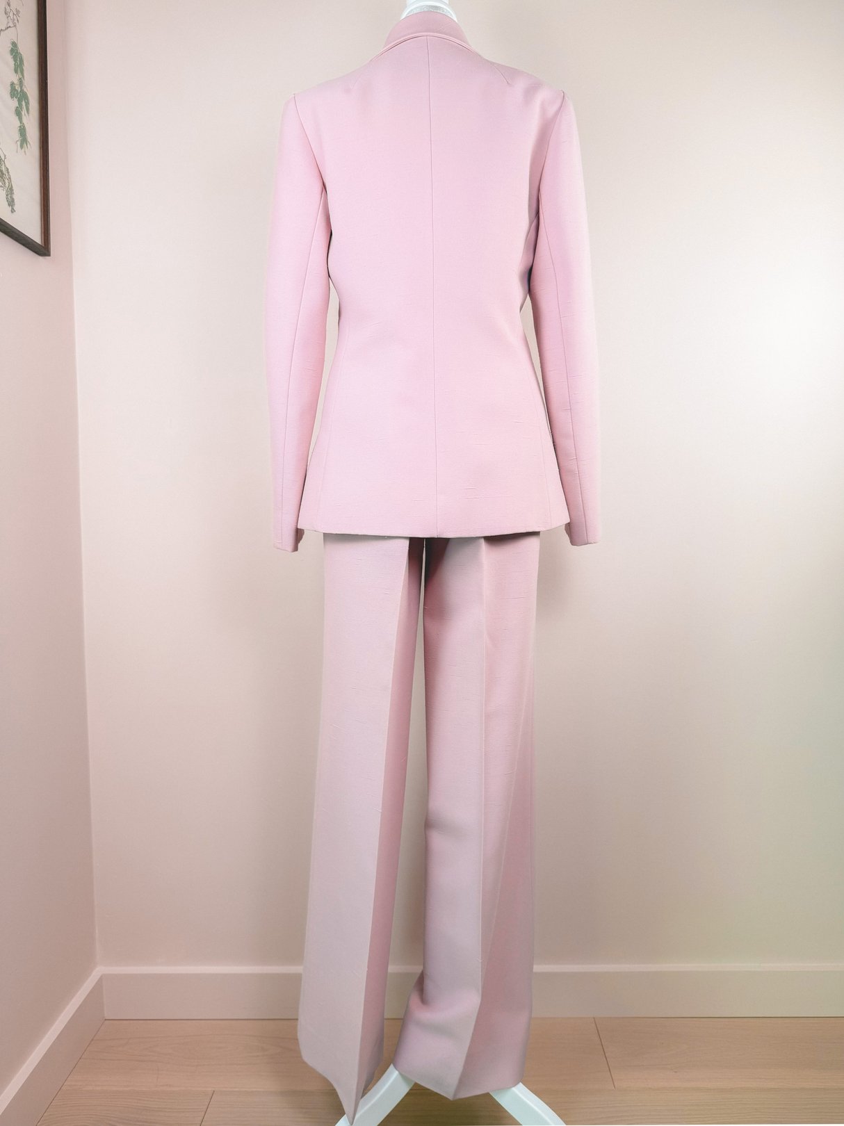 Back view of a 1970s women's blush pink Lilli Ann three-piece suit, featuring a fitted blazer, matching trousers, and a minimalist design.