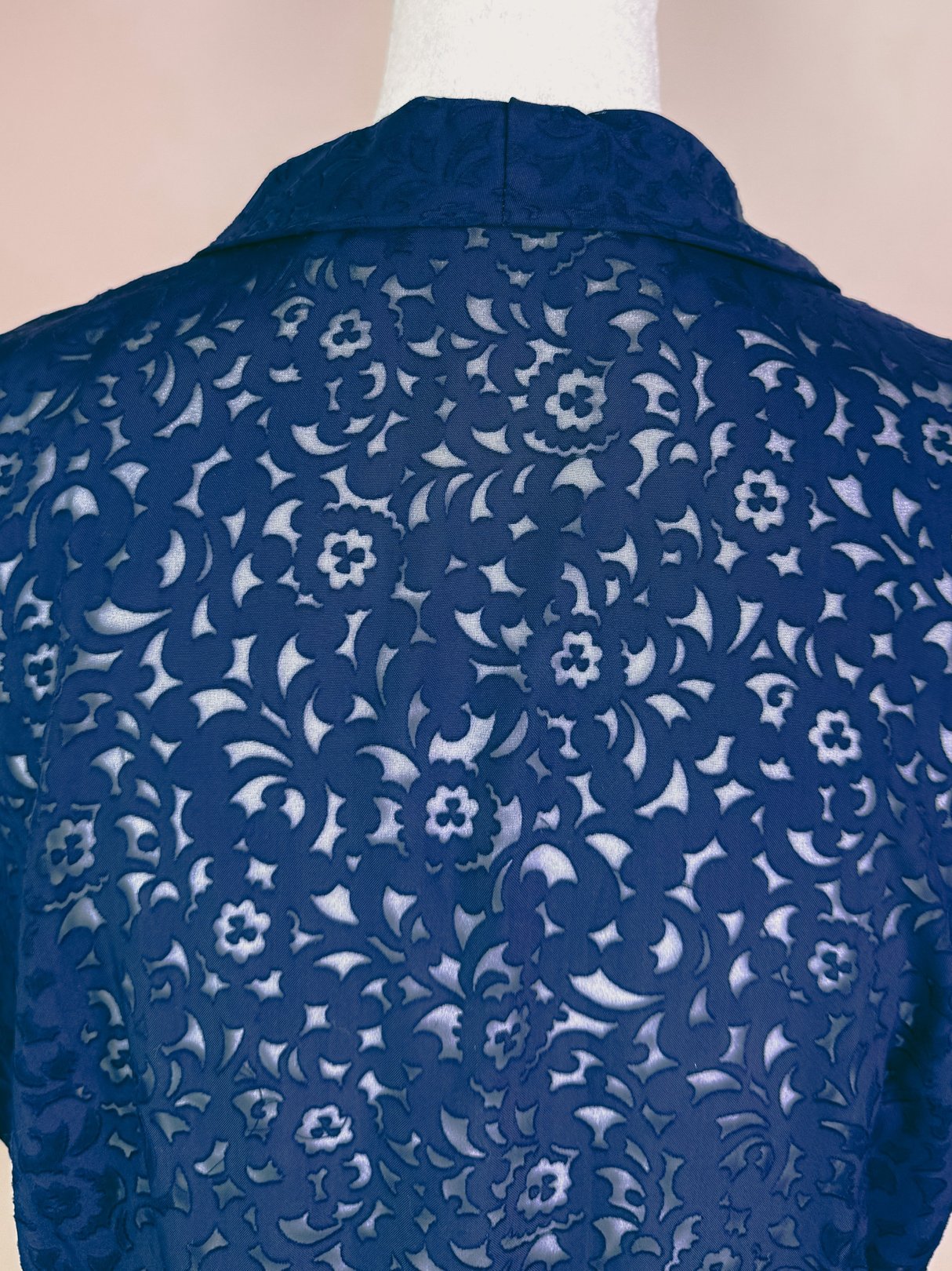 Navy blue fabric featuring intricate floral lace patterns, suitable for a women's dress inspired by 1940s fashion.