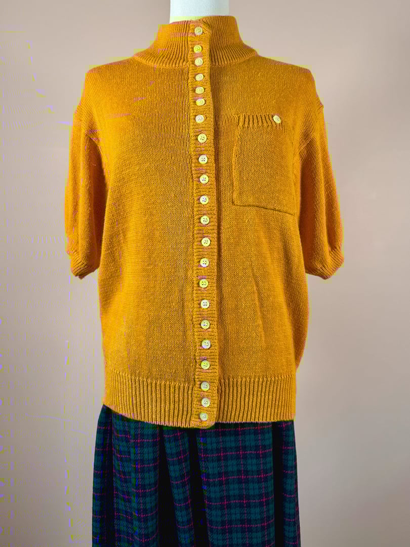 Persimmon orange 1980s women's sweater featuring a button-down front, short sleeves, and a single chest pocket.