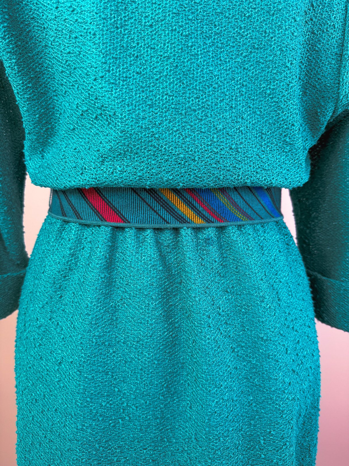 Teal Tempo Dress featuring a textured fabric and a colorful striped belt, designed for women, from the 1980s.