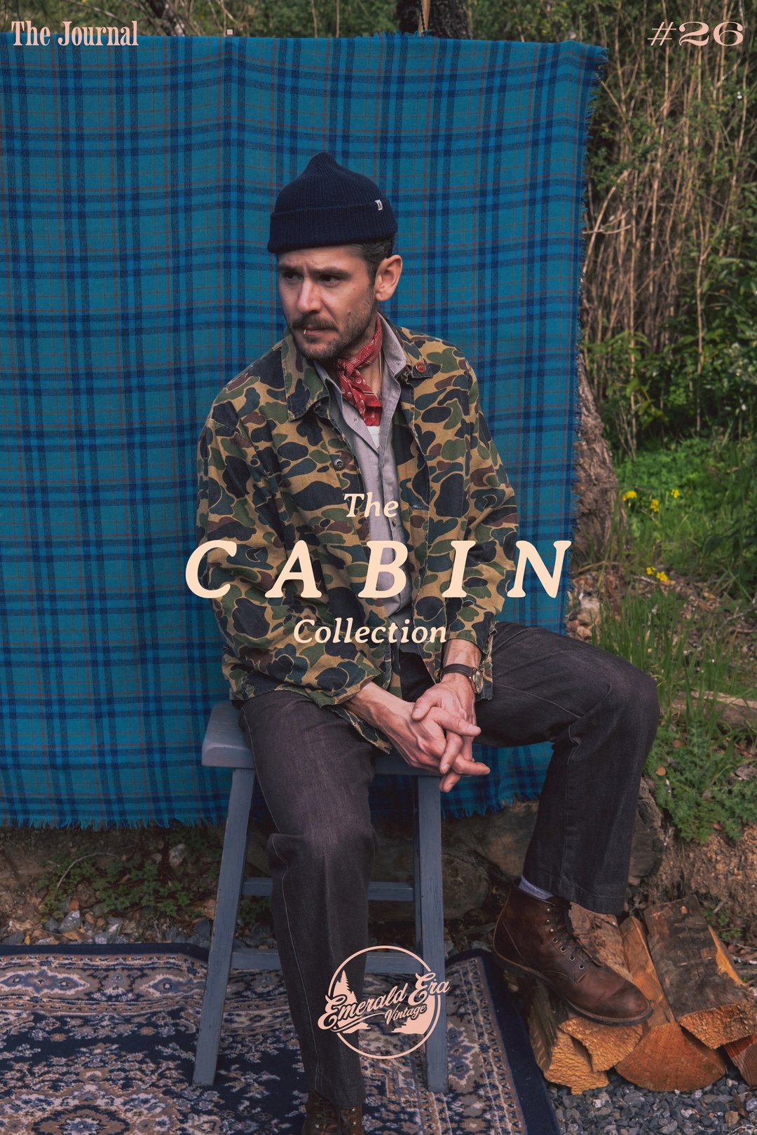 A man wearing a camo shirt and a beanie sits on a chair against a blue plaid background, promoting "The Cabin Collection.