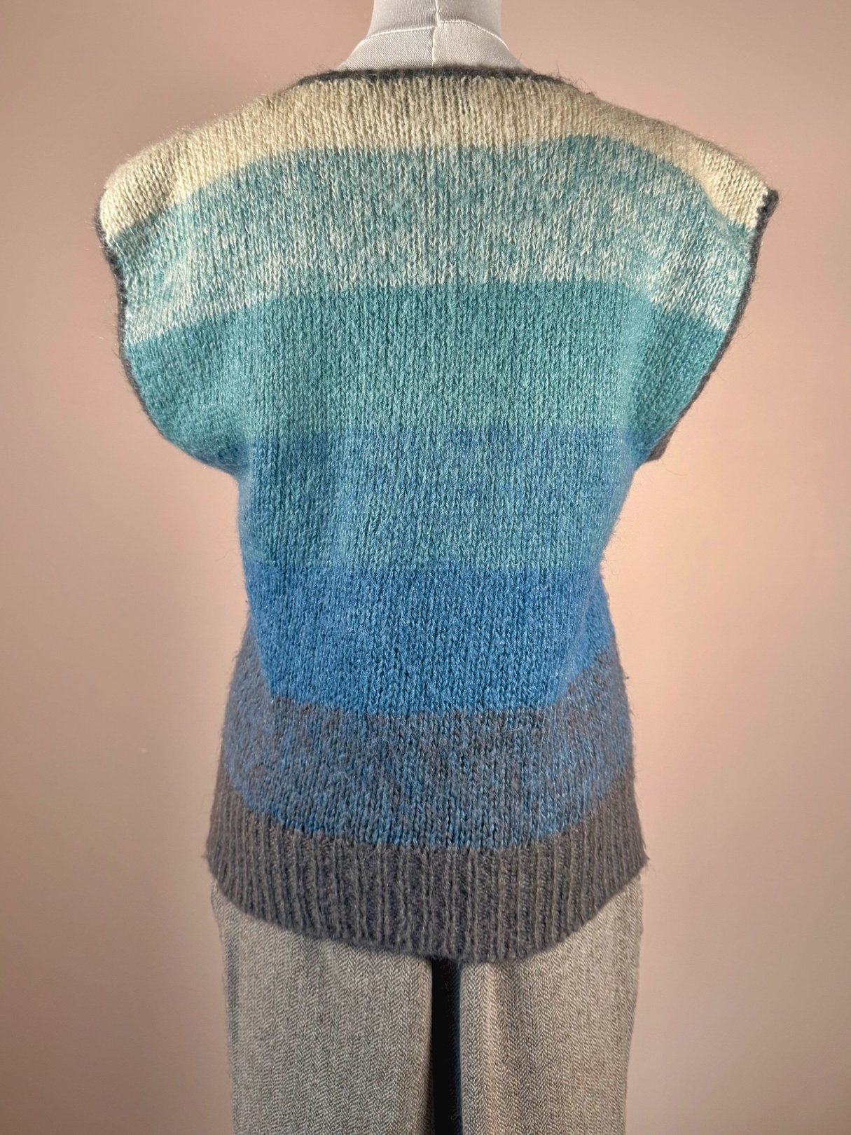 Light blue and teal striped mohair sweater vest for women, featuring a 1970s design.
