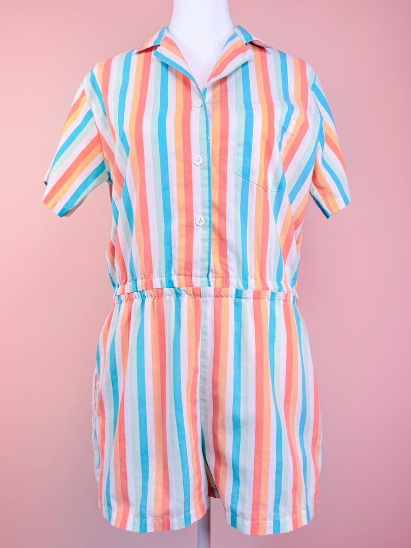 Blue striped romper featuring short sleeves, a collar, and an elastic waistband, designed for women in the 1980s.