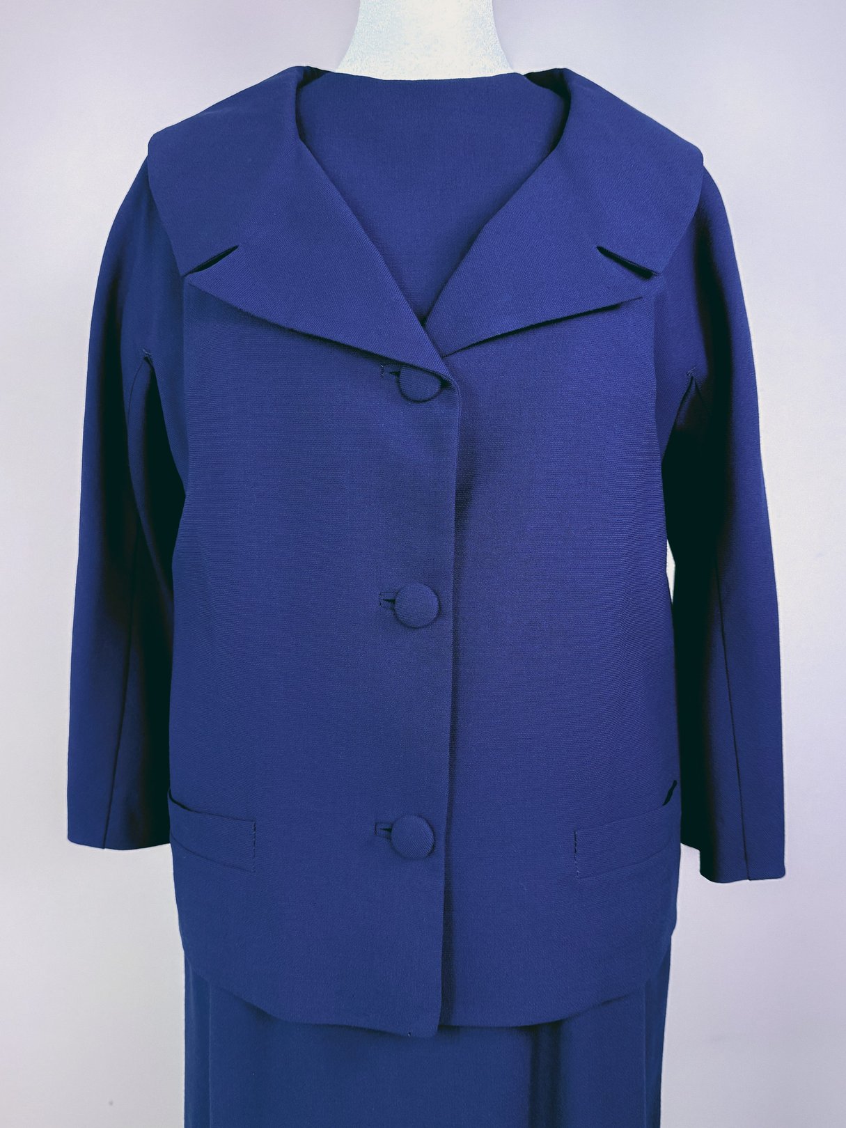 Navy blue 1960s women's dress set featuring a button-up jacket with a wide collar and matching dress.