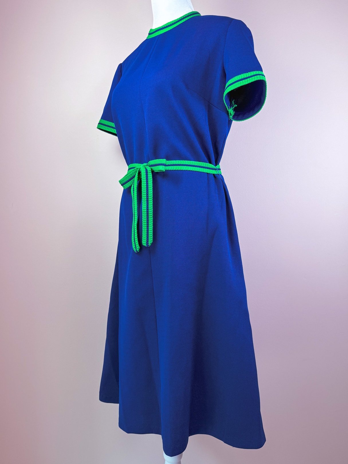 1970s women's Pacific Lines dress in blue with green striped trim and a matching belt.