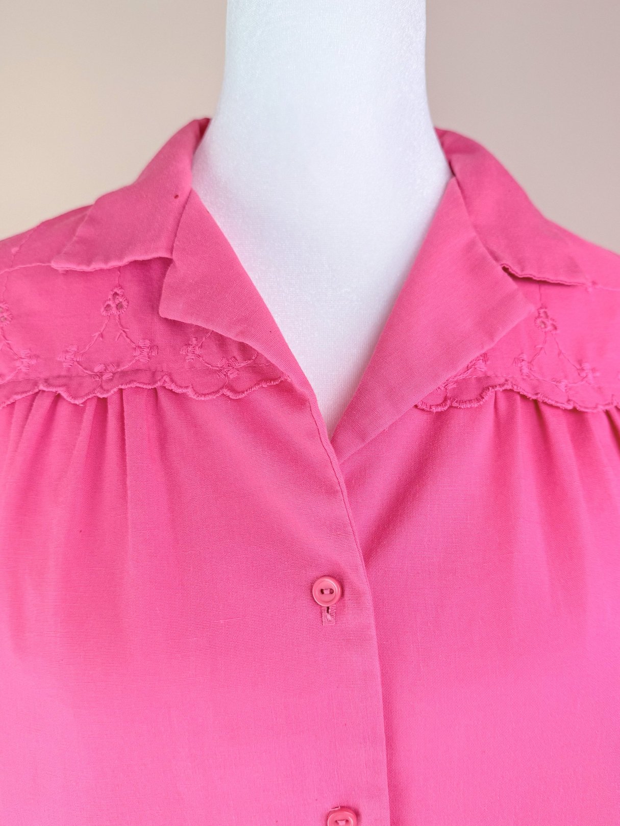 Pink women's 1980s top featuring lace detailing and a button-up front.
