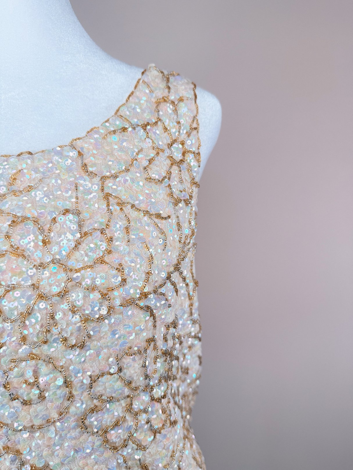 White 1960s women's Champagne Blossom Top featuring floral sequin embellishments in pastel hues and gold detailing.
