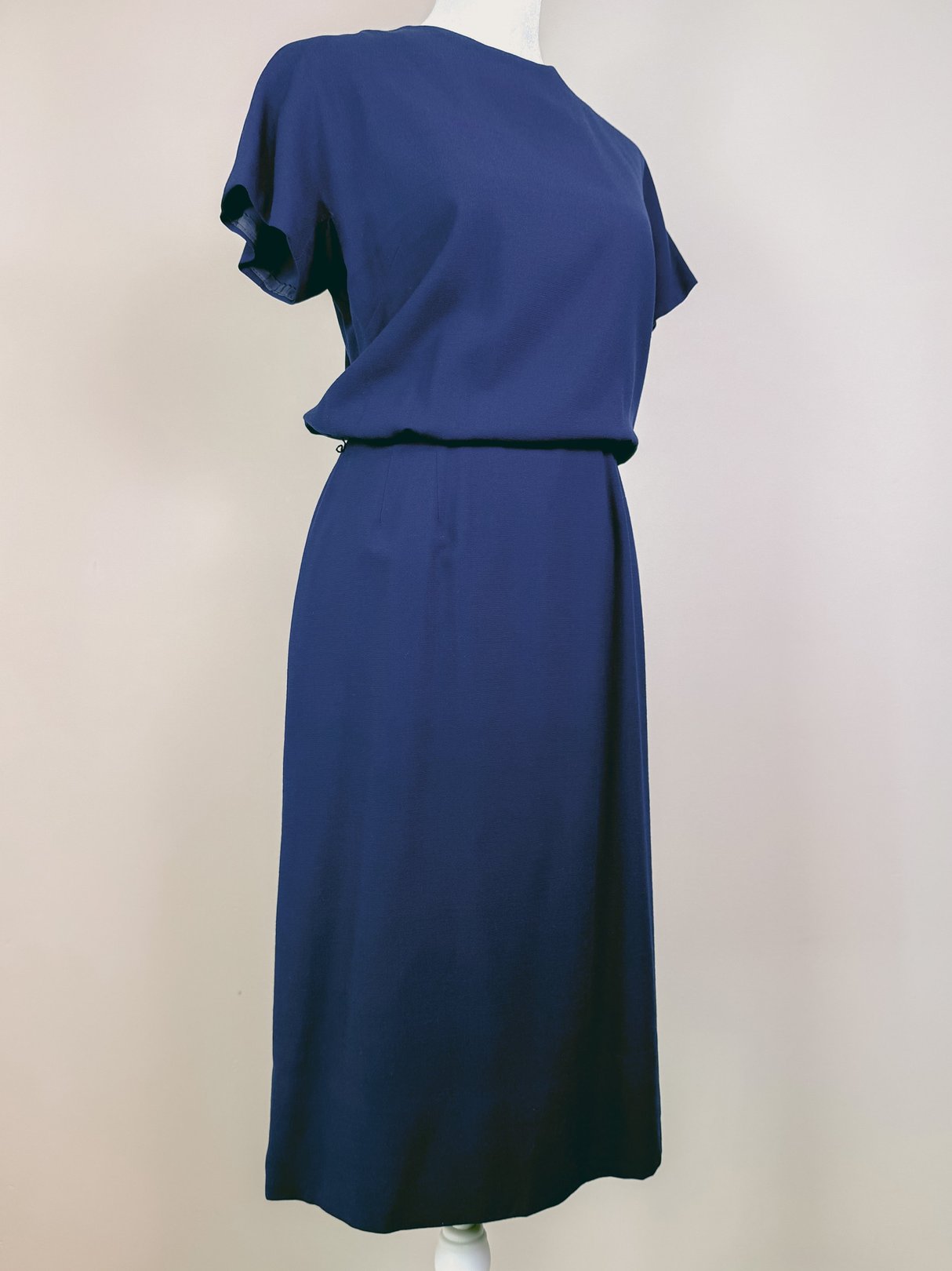 Navy blue women's dress set from the 1960s featuring a simple, relaxed silhouette with short sleeves and a belted waist.