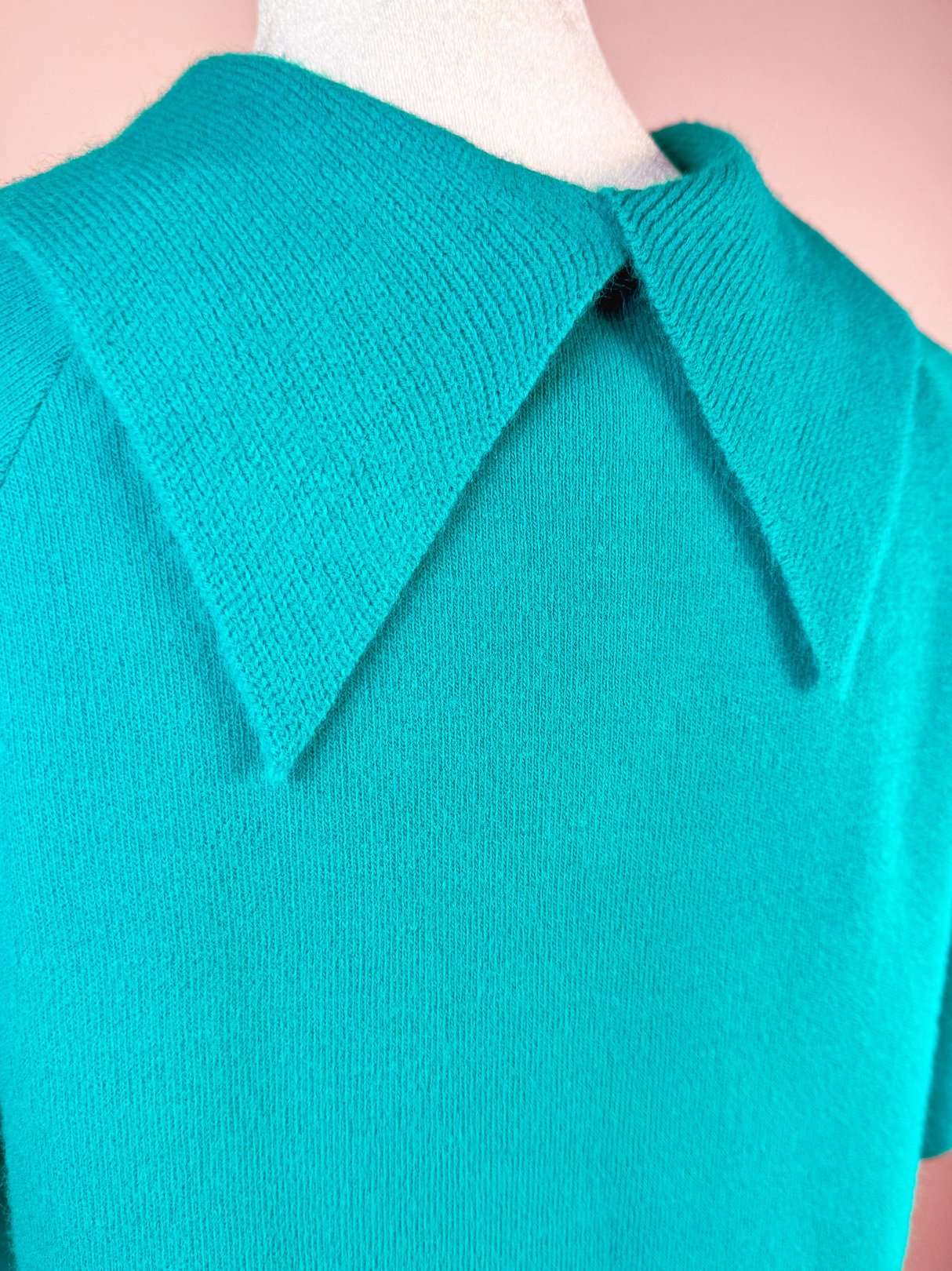 Teal green knit skirt set featuring a collared top, inspired by 1960s fashion.