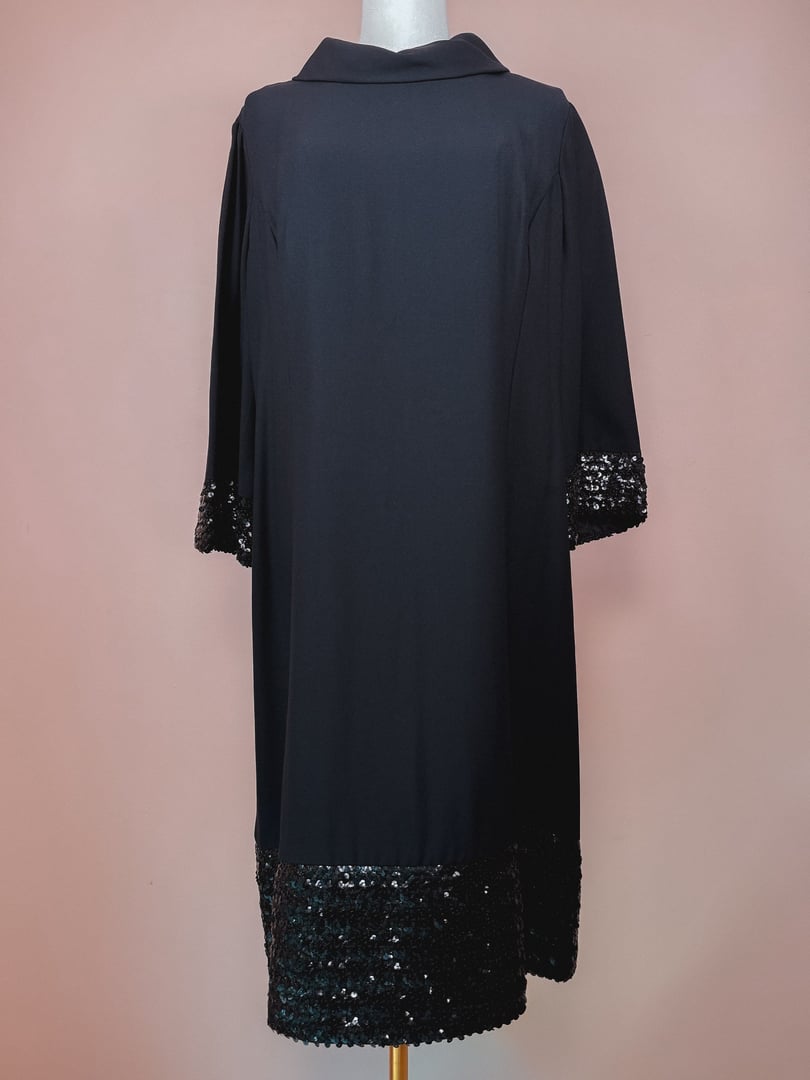 Black Mod Sparkle Dress for women featuring a collar and sequined detailing at the sleeves and hem, designed in a 1960s style.