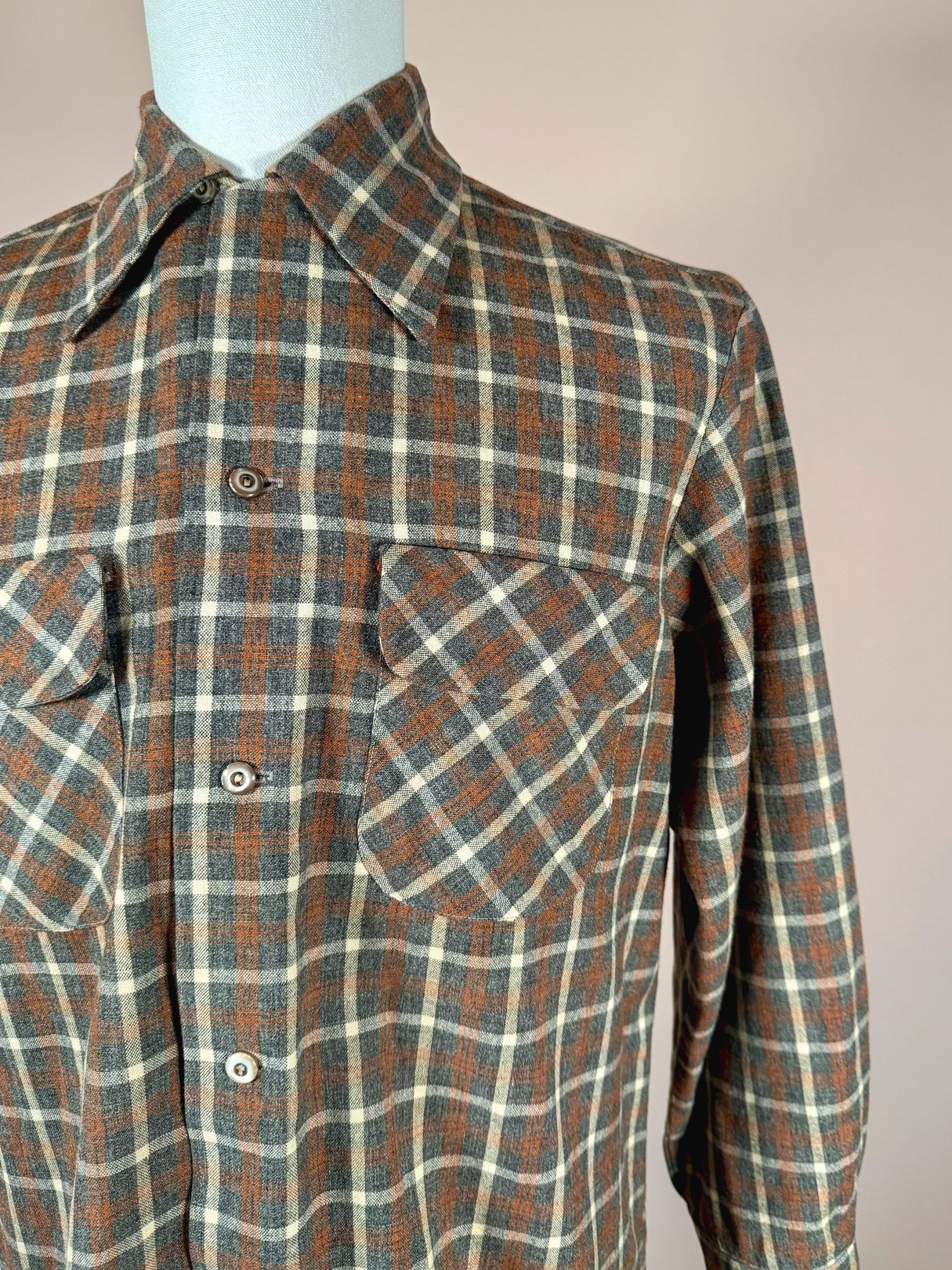 Grey plaid shirt featuring two chest pockets, designed for men, styled in a 1950s aesthetic.