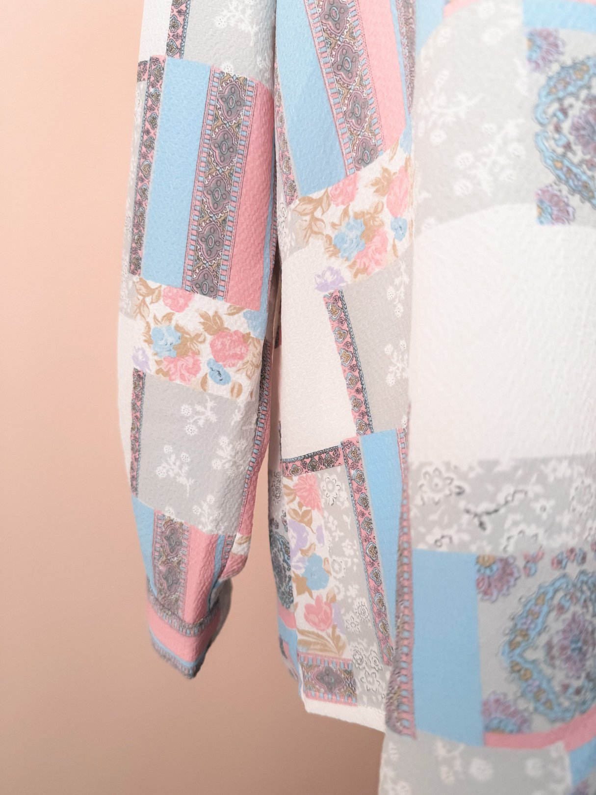 White patchwork blouse for women featuring a mix of pink, blue, and floral patterns, inspired by 1980s fashion.