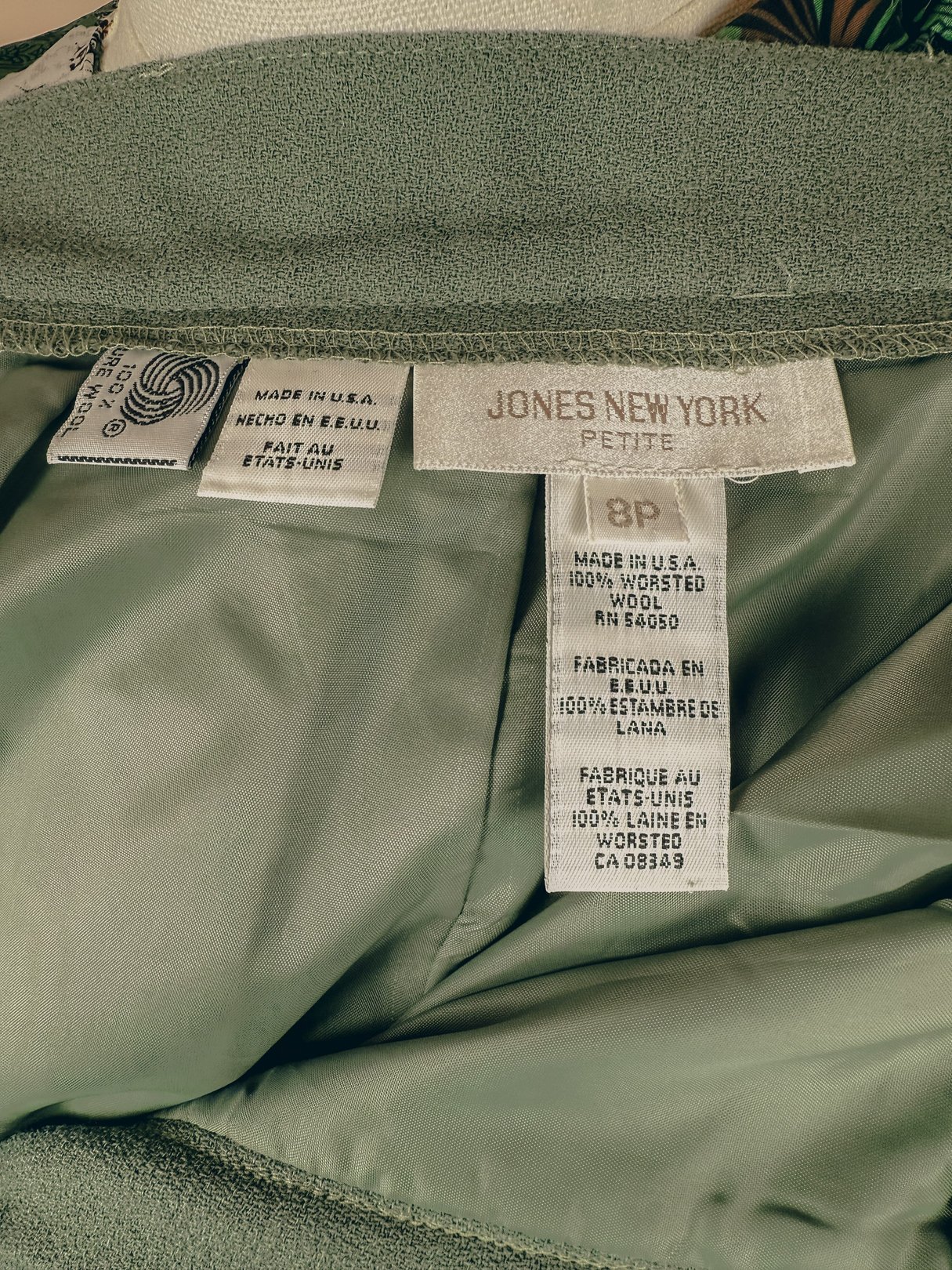 Sage green pleated trousers for women, labeled as size 18P, from the 1980s by Jones New York.
