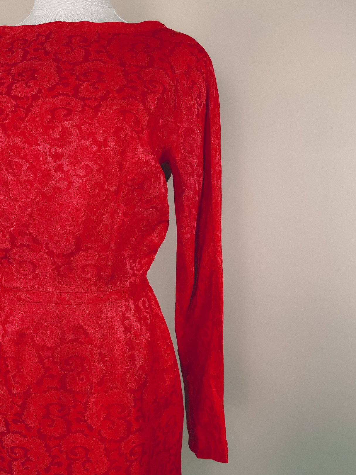 Red damask dress for women featuring long sleeves, showcasing a textured floral pattern.