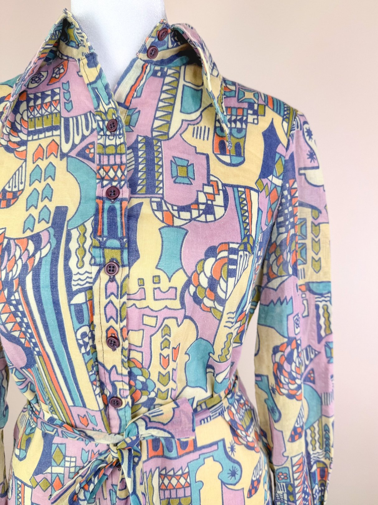 Cream 1970s Metropolis Dress for women featuring a colorful geometric pattern and a belted waist.