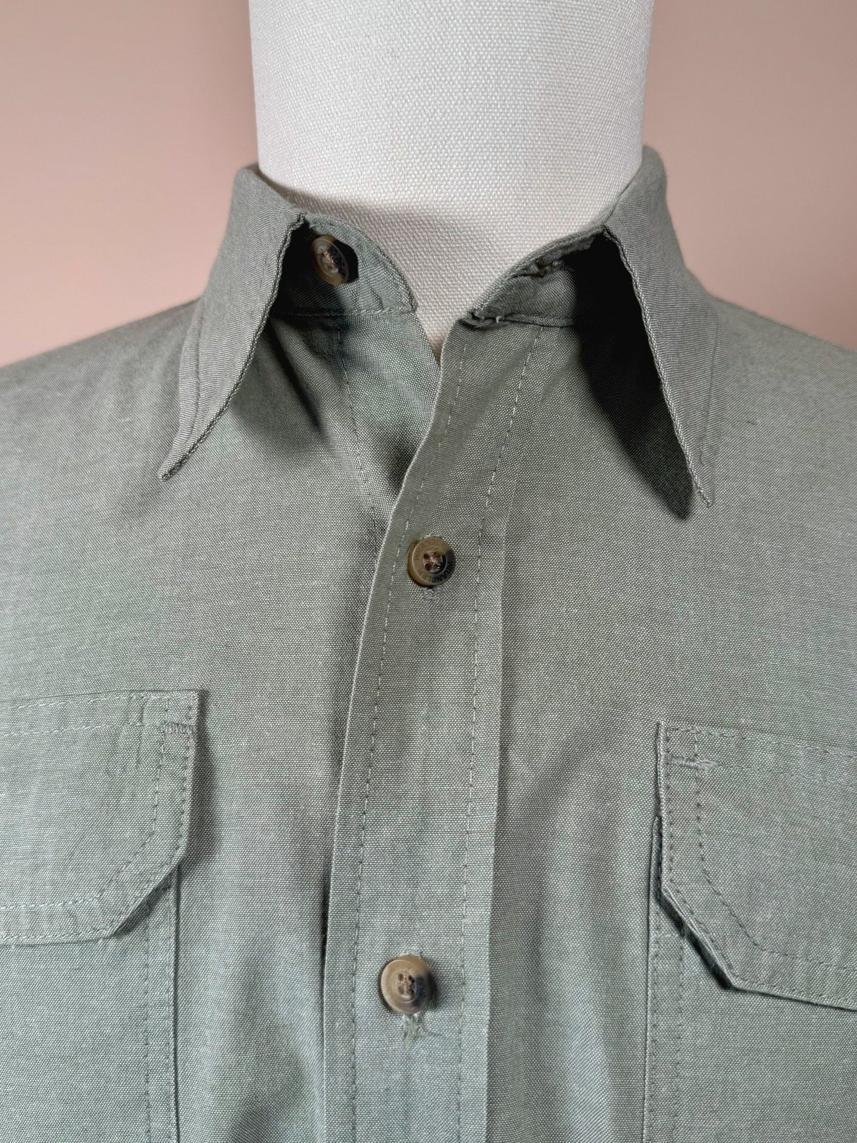 Sage green Wrangler Authentics camp shirt for men featuring button closure and two chest pockets, styled for the 1990s era.